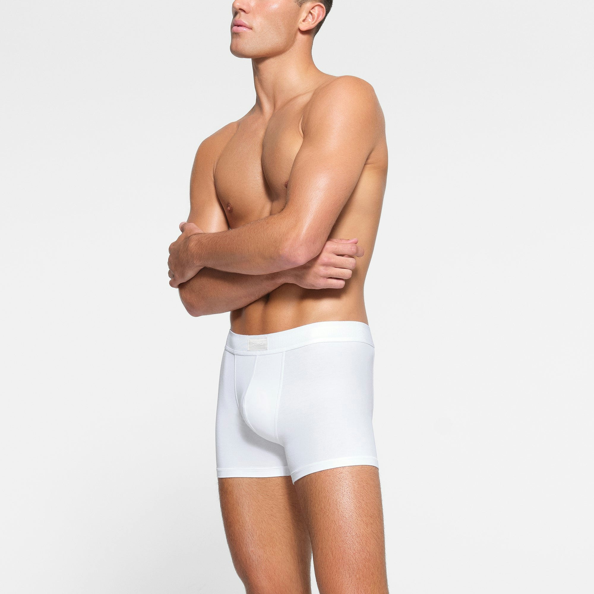 SKIMS COTTON MENS 3" BOXER BRIEF 3-PACK WORN BY A MODEL IN SIDE VIEW