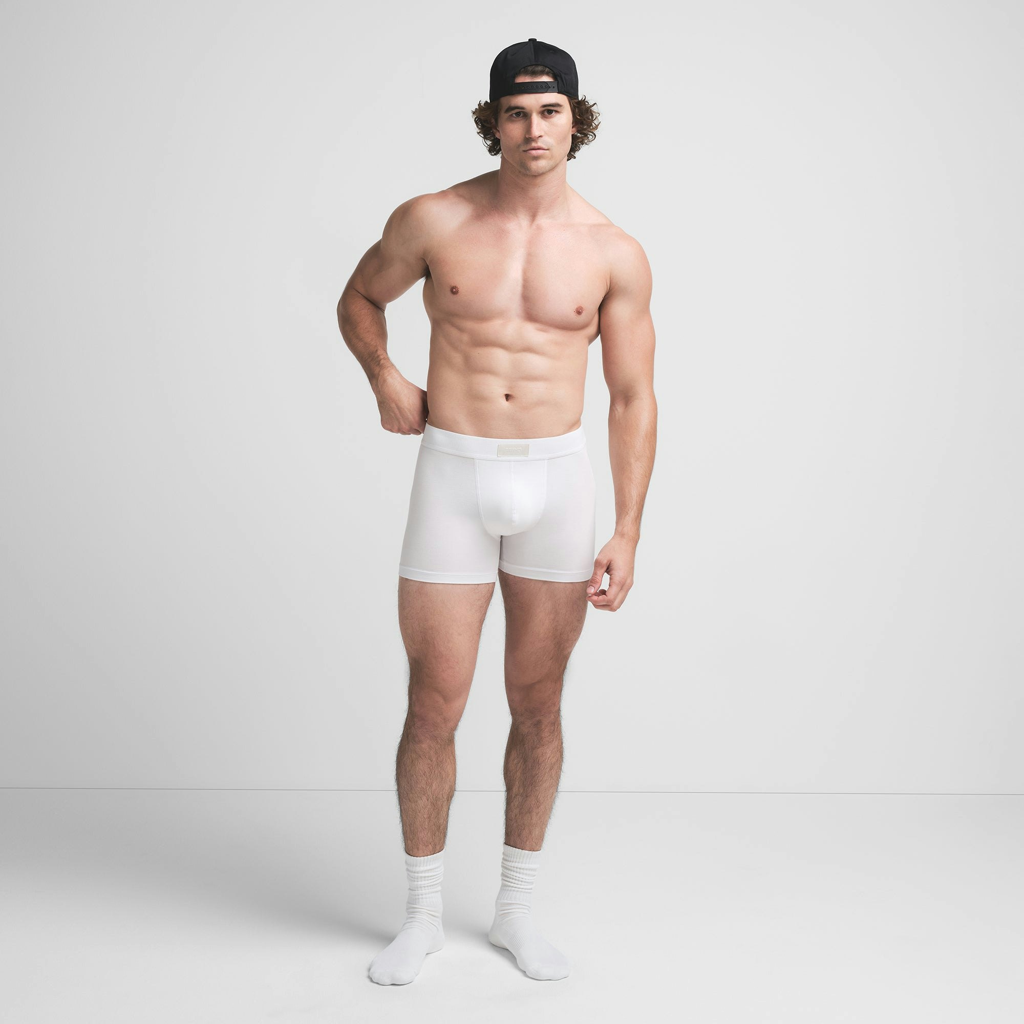 SKIMS COTTON MENS 3" BOXER BRIEF | CHALK ON A MODEL FRONT VIEW @ | FOCUS: 0.9, 0.1, 0.7
