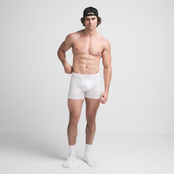 SKIMS COTTON MENS 3" BOXER BRIEF | CHALK ON A MODEL FRONT VIEW @ | FOCUS: 0.9, 0.1, 0.7