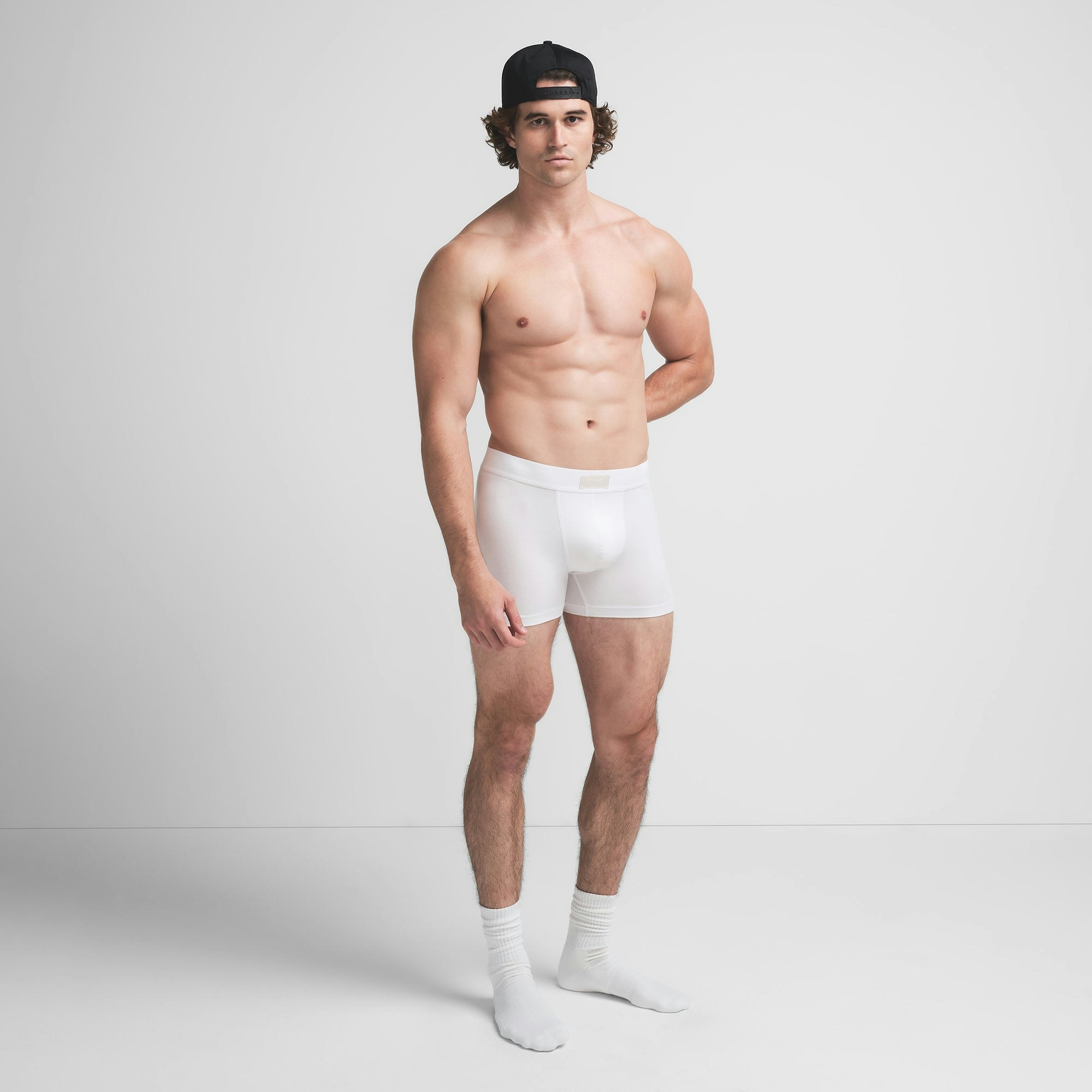 SKIMS COTTON MENS 3" BOXER BRIEF | CHALK ON A MODEL FRONT VIEW @ | FOCUS: 0.9, 0.1, 0.7