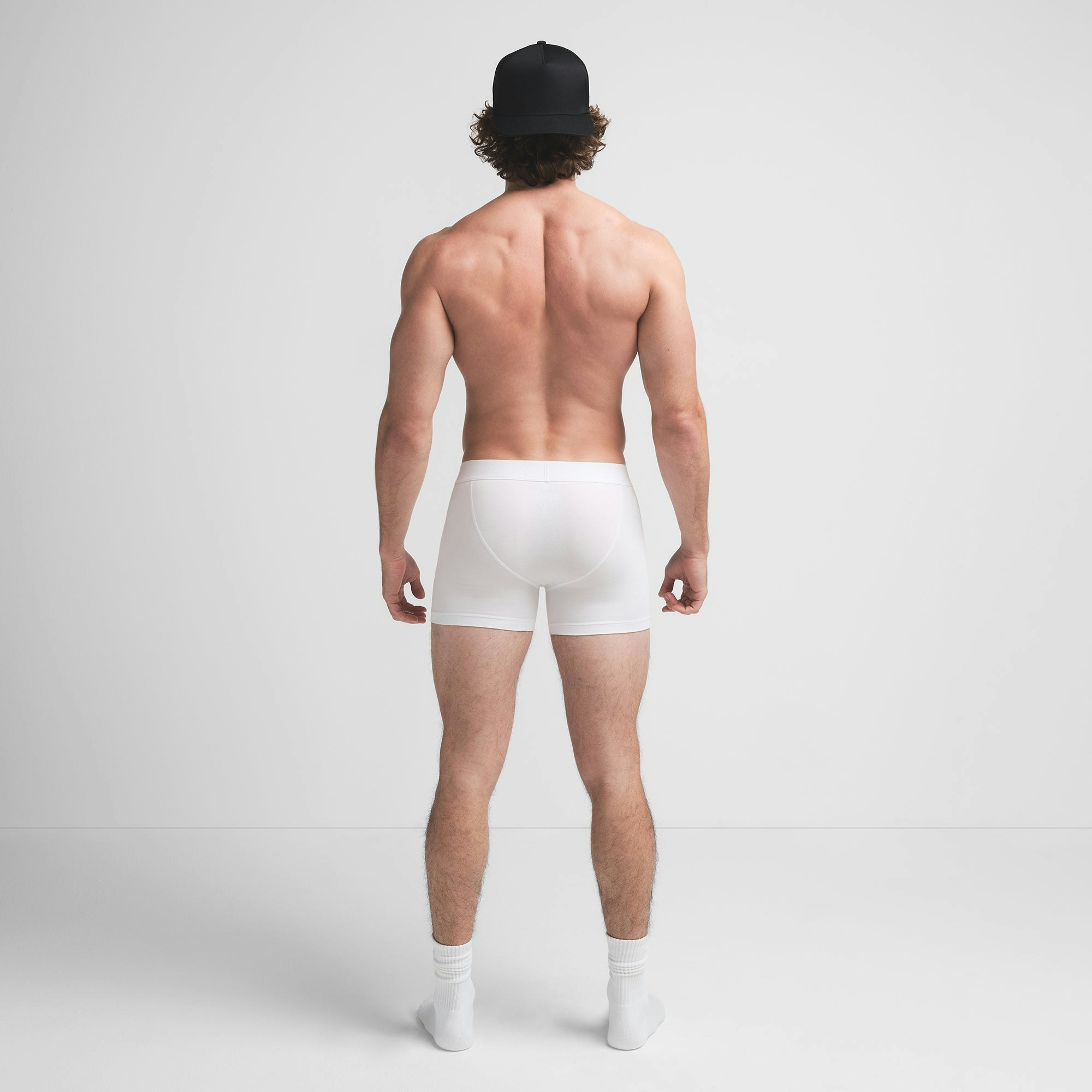 SKIMS COTTON MENS 3" BOXER BRIEF | CHALK ON A MODEL BACK VIEW @ | FOCUS: 0.9, 0.1, 0.7