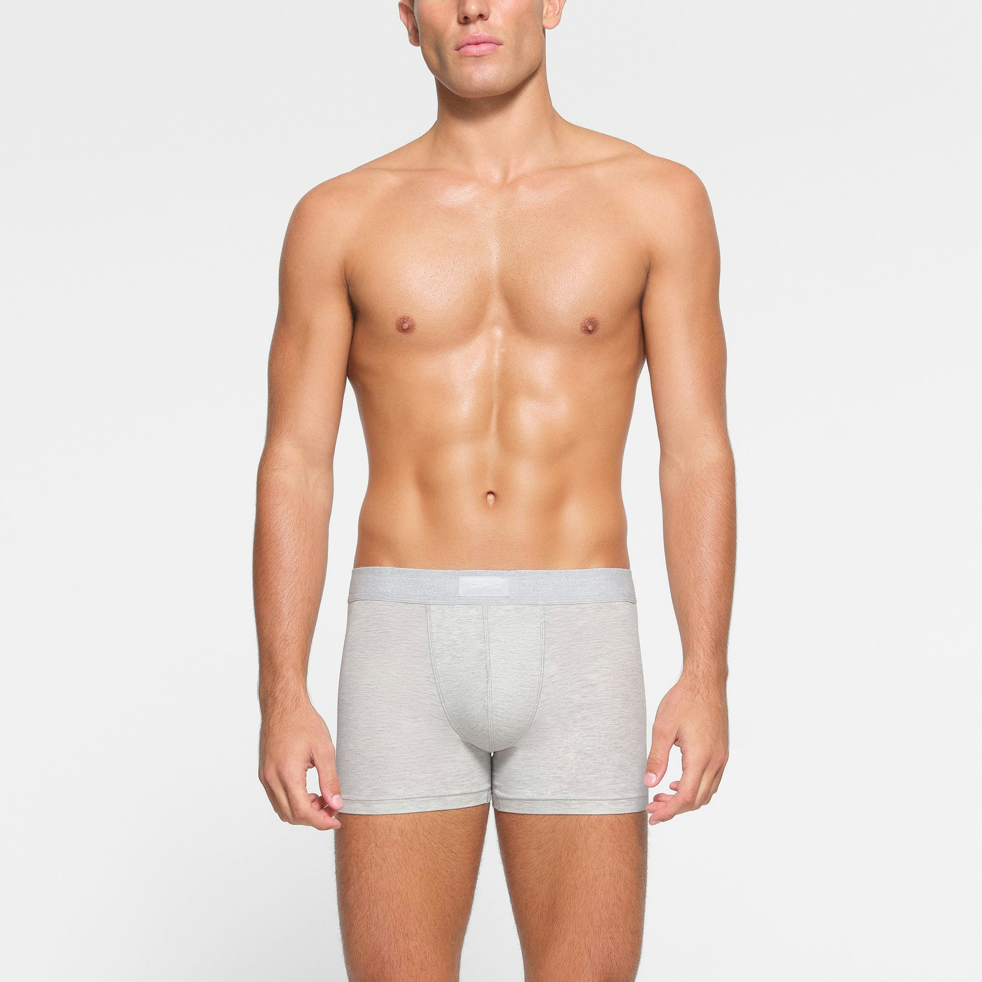 SKIMS COTTON MENS 3" BOXER BRIEF 3-PACK WORN BY A MODEL IN FRONT VIEW