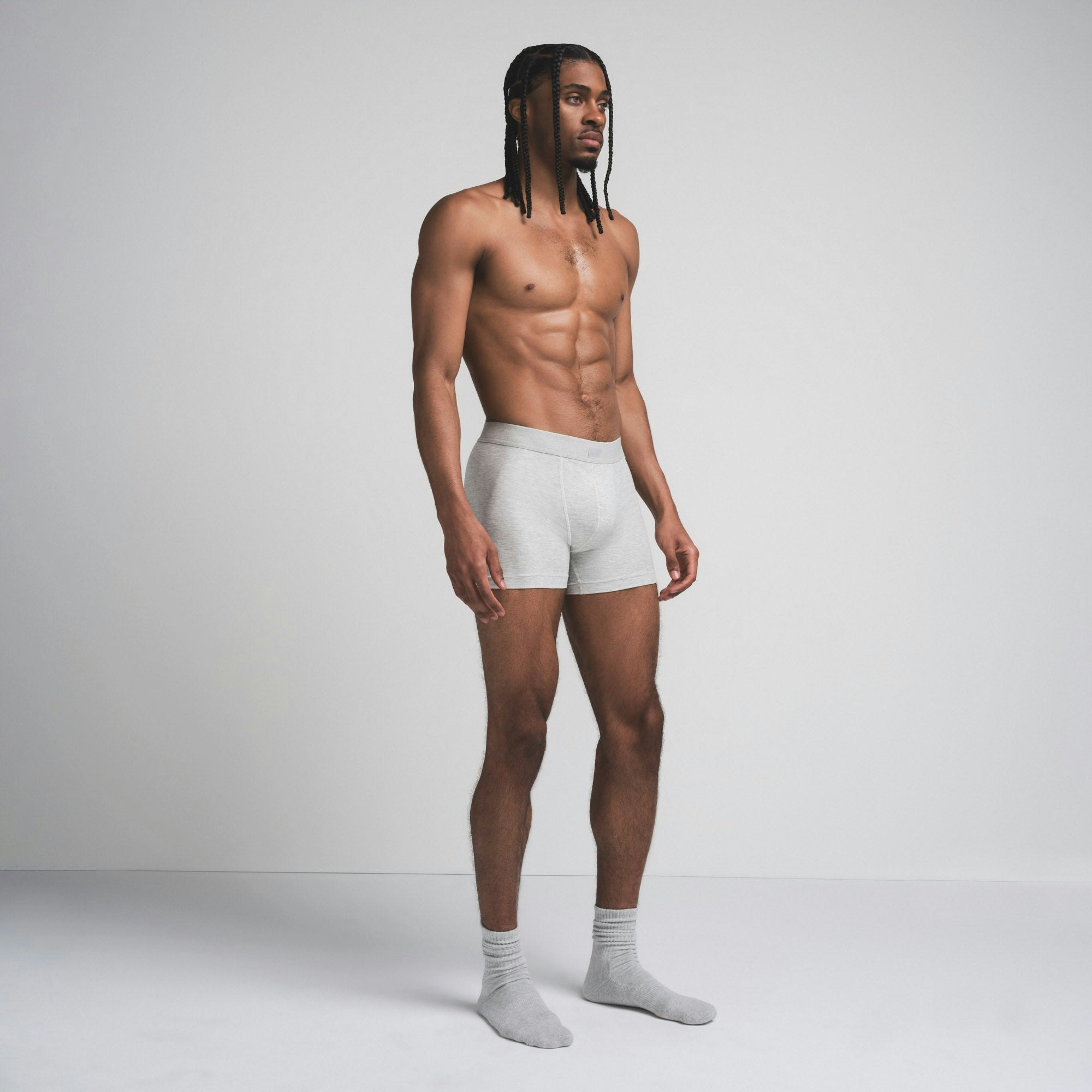 SKIMS COTTON MENS 3" BOXER BRIEF | LIGHT HEATHER GREY ON A MODEL SIDE VIEW @ | FOCUS: 0.9, 0.1, 0.7
