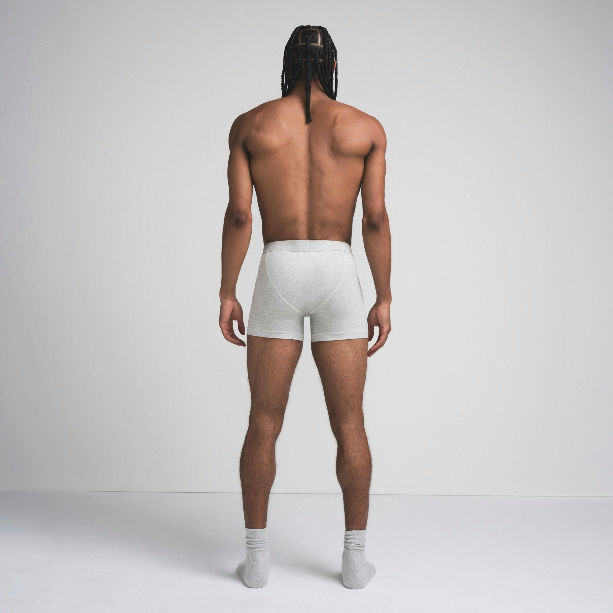 SKIMS COTTON MENS 3" BOXER BRIEF | LIGHT HEATHER GREY ON A MODEL SIDE VIEW @ | FOCUS: 0.9, 0.1, 0.7
