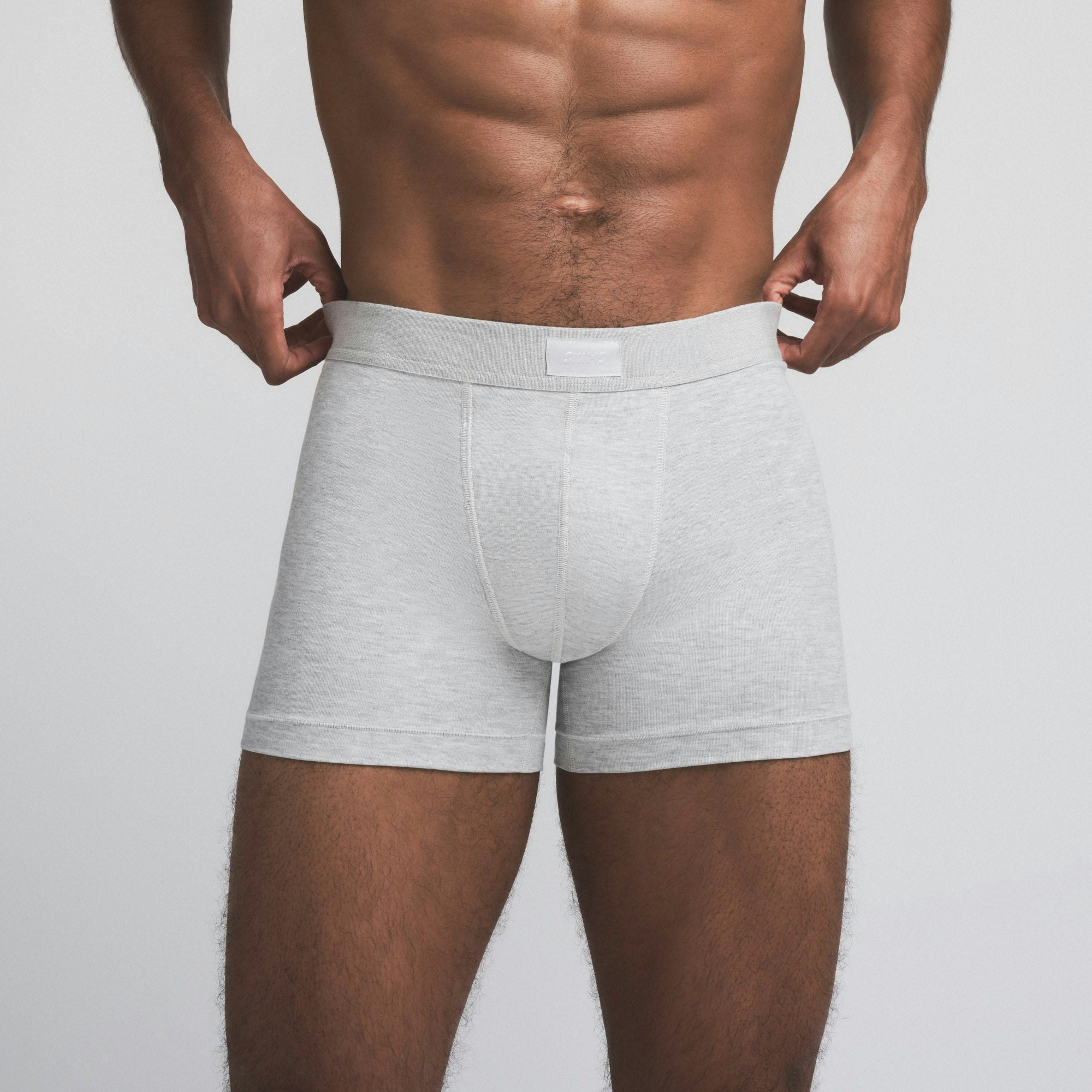 SKIMS COTTON MENS 3" BOXER BRIEF | LIGHT HEATHER GREY ON A MODEL SIDE VIEW @ | FOCUS: 0.9, 0.1, 0.7