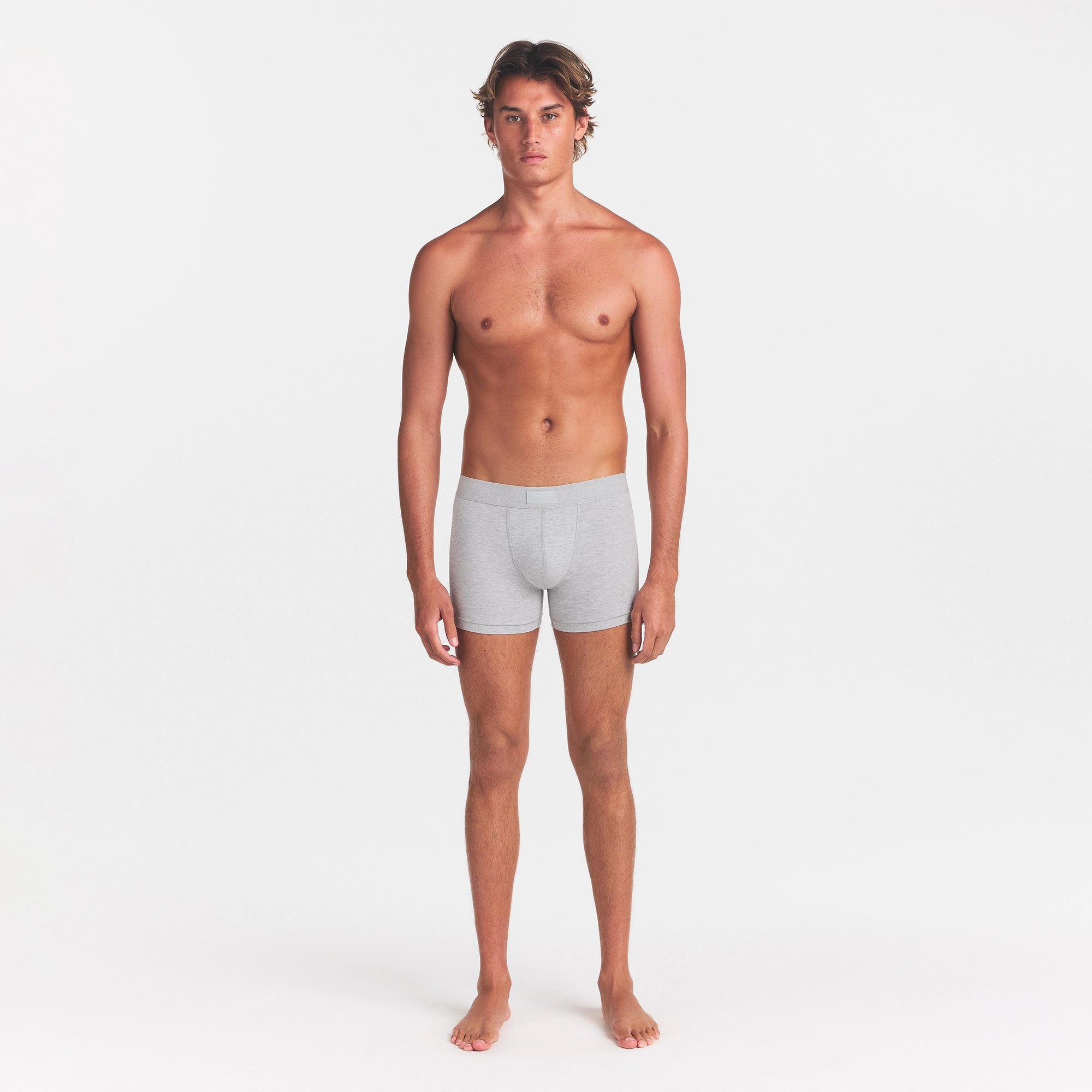 SKIMS COTTON MENS 3" BOXER BRIEF | LIGHT HEATHER GREY ON A MODEL FRONT VIEW @ | FOCUS: 0.0, 1.0, 0.9
