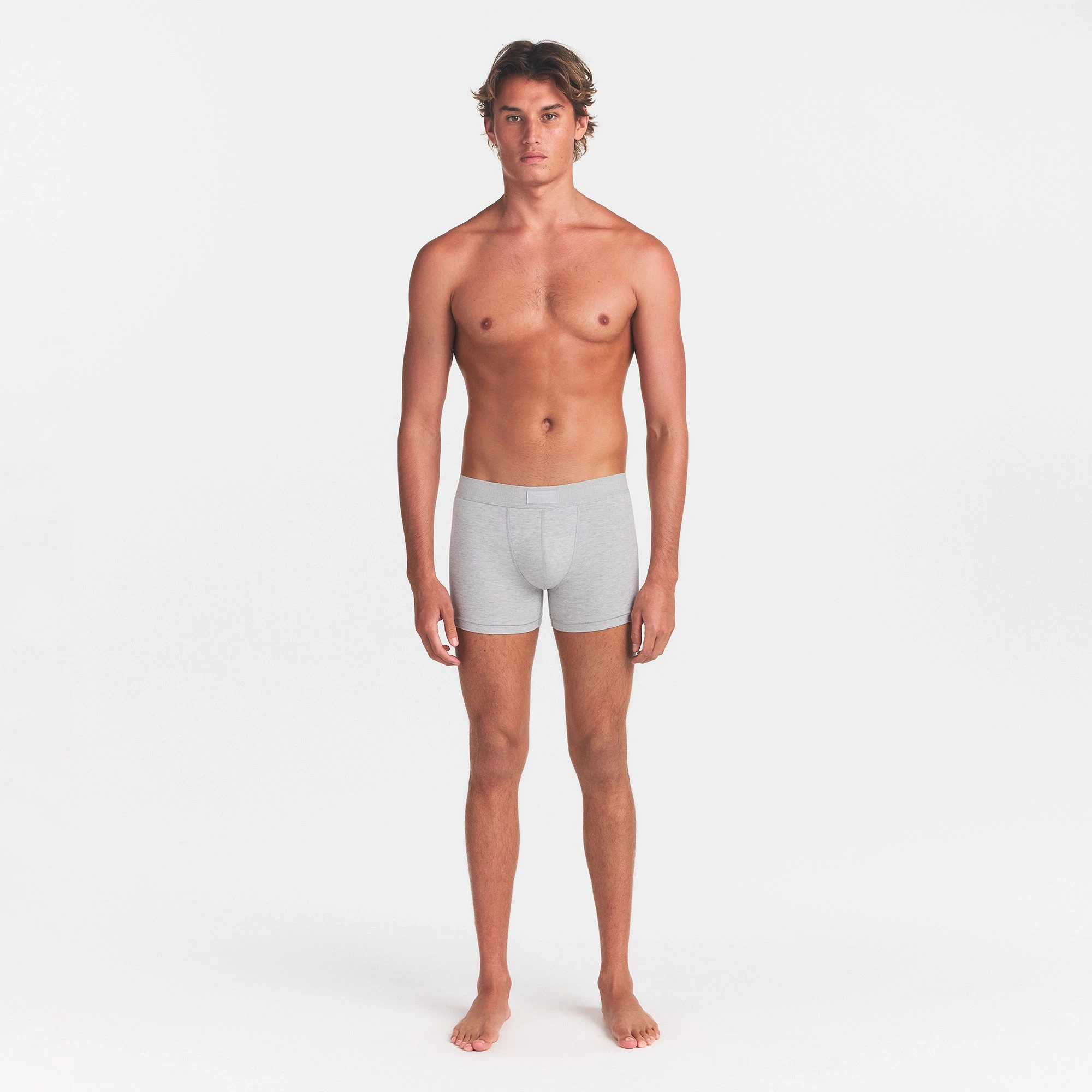 SKIMS COTTON MENS 3" BOXER BRIEF | LIGHT HEATHER GREY ON A MODEL FRONT VIEW