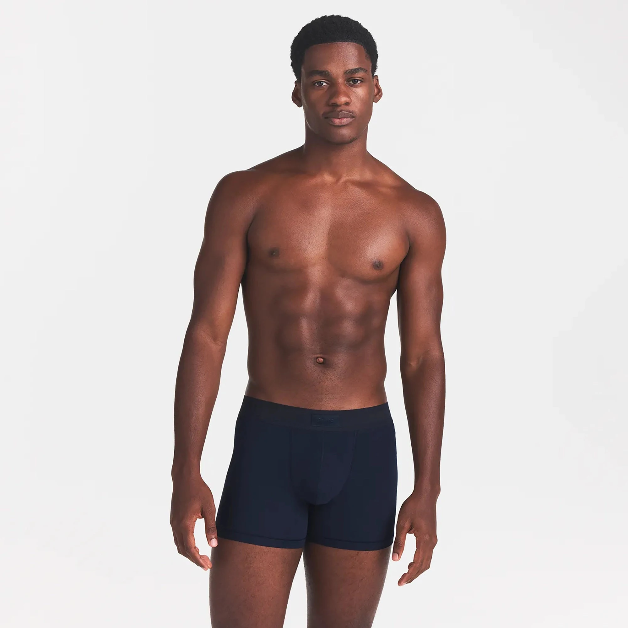 SKIMS COTTON MENS 3" BOXER BRIEF | NAVY ON A MODEL FRONT VIEW