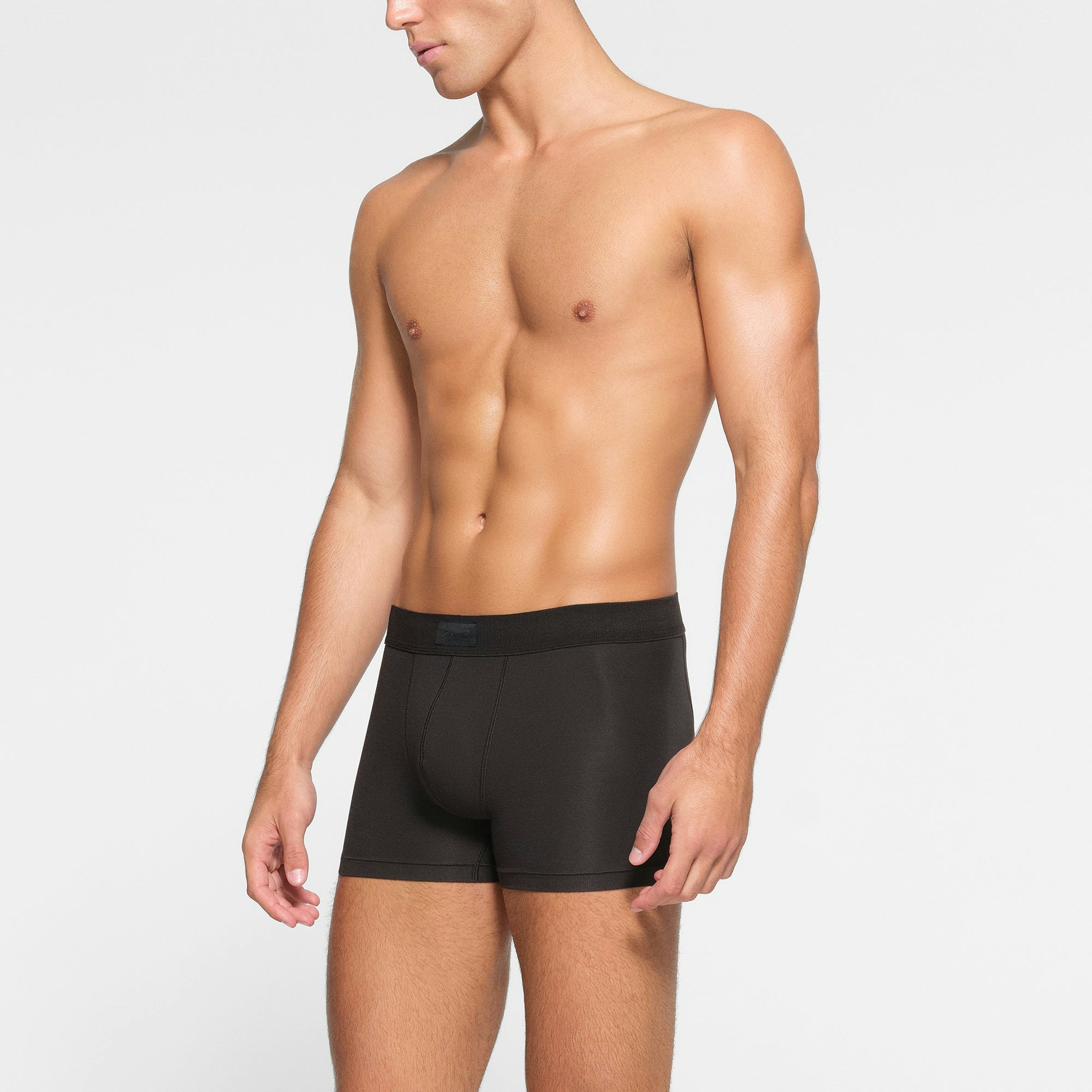 SKIMS COTTON MENS 3" BOXER BRIEF 3-PACK WORN BY A MODEL IN SIDE VIEW