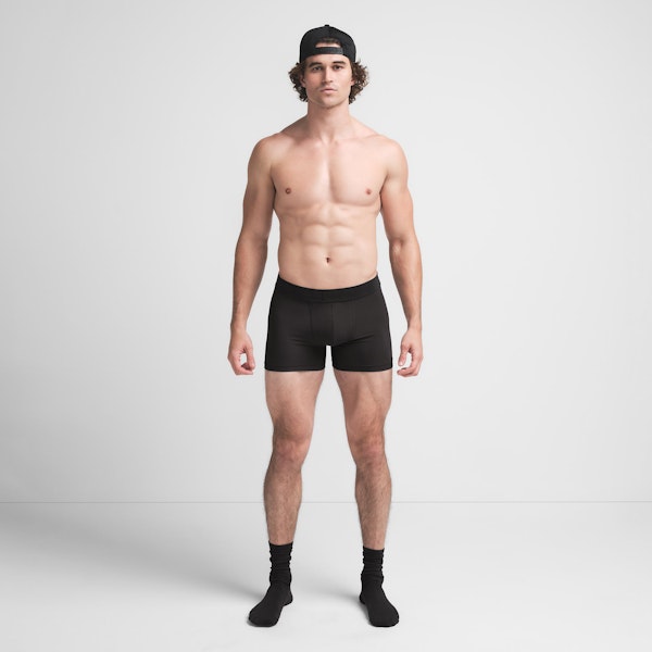 SKIMS COTTON MENS 3" BOXER BRIEF | ONYX ON A MODEL FRONT VIEW @ | FOCUS: 0.9, 0.1, 0.7