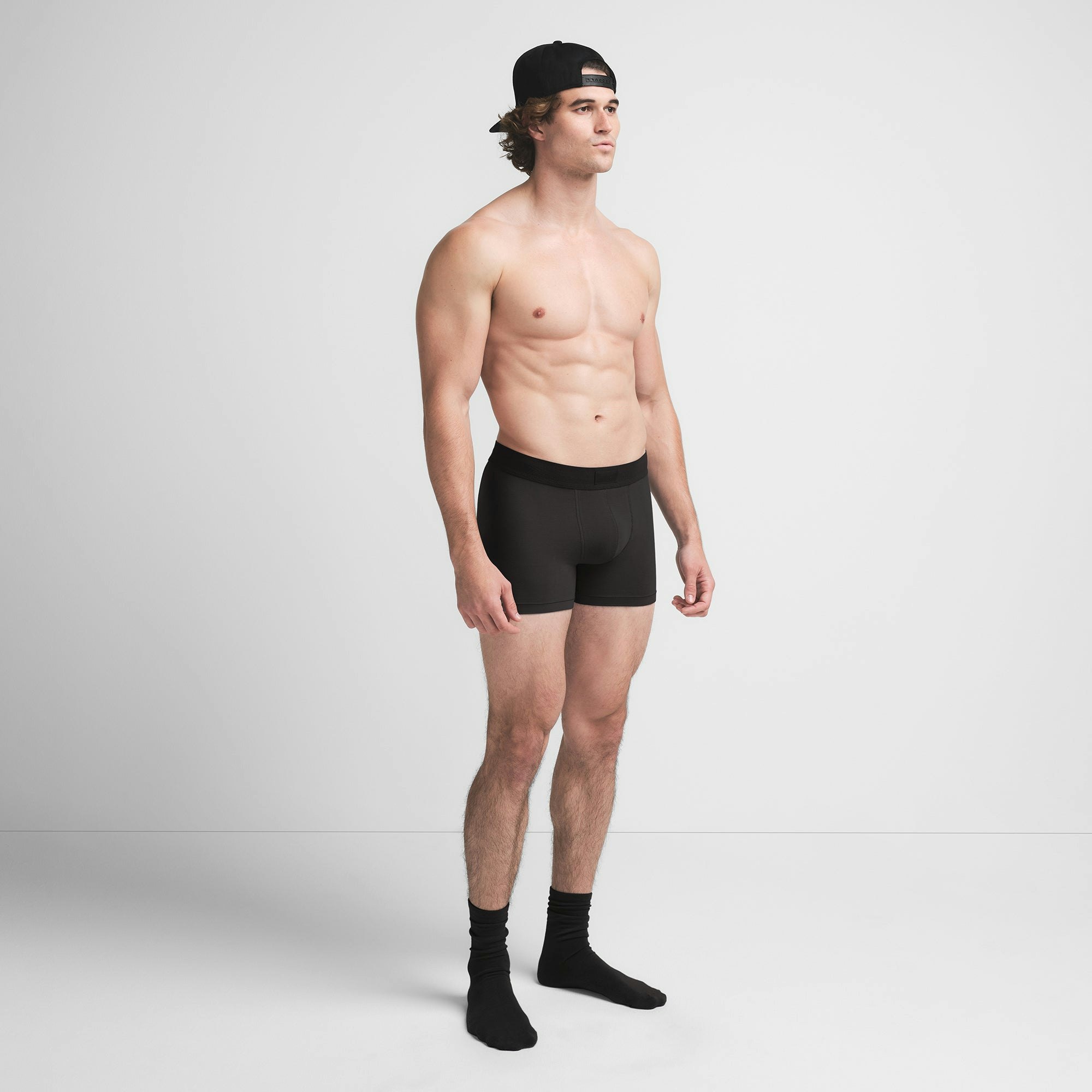 SKIMS COTTON MENS 3" BOXER BRIEF | ONYX ON A MODEL SIDE VIEW @ | FOCUS: 0.9, 0.1, 0.7
