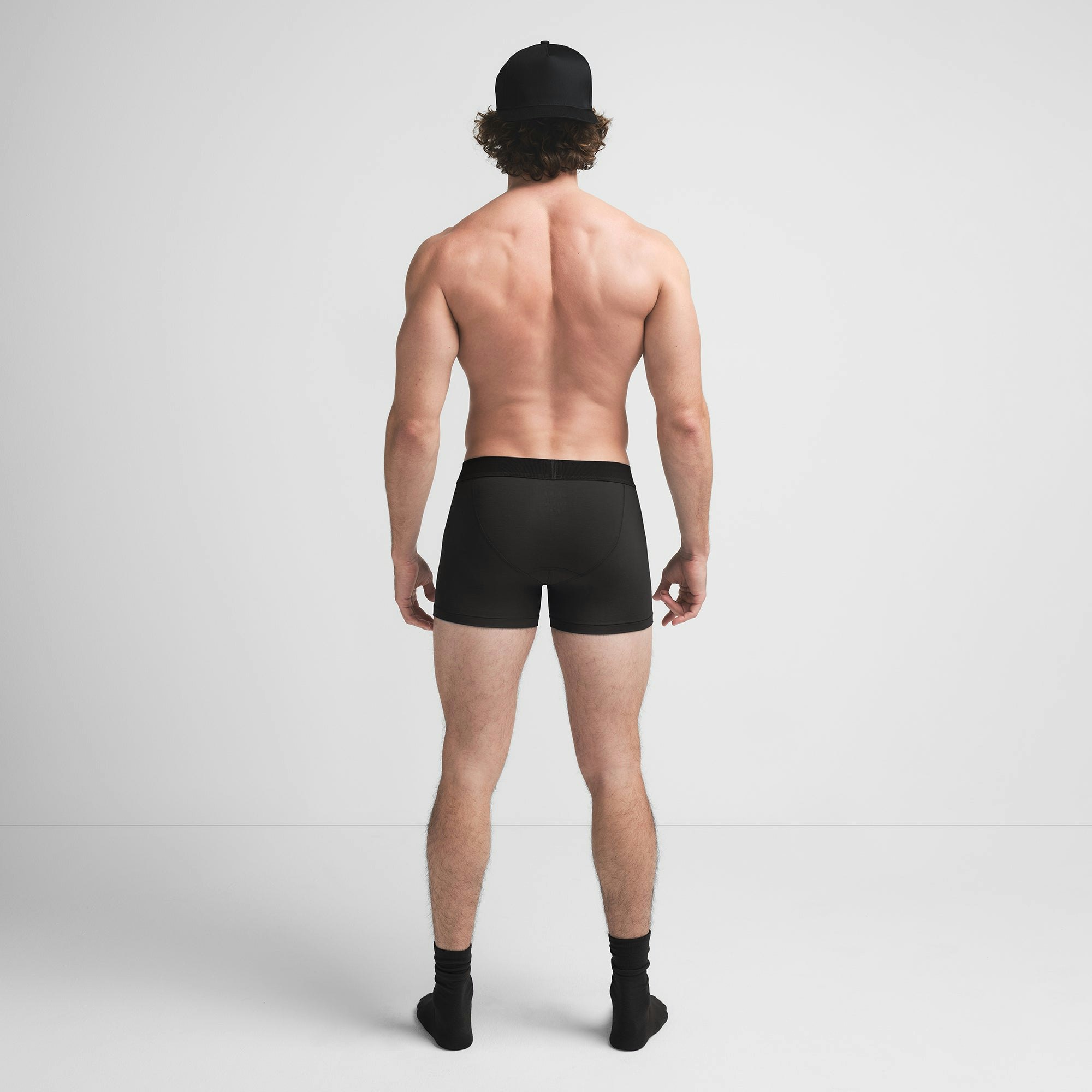 SKIMS COTTON MENS 3" BOXER BRIEF | ONYX ON A MODEL BACK VIEW @ | FOCUS: 0.9, 0.1, 0.7