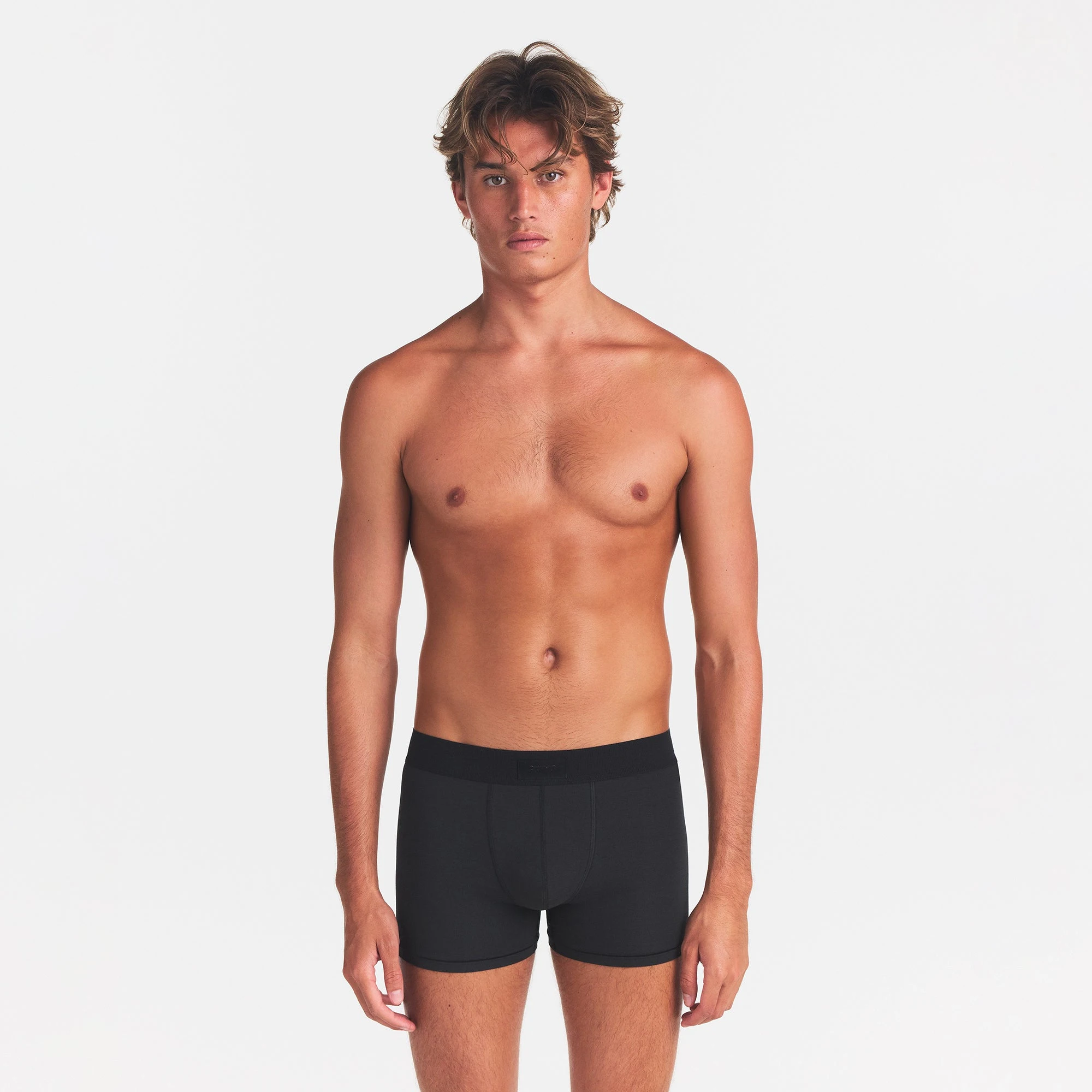 SKIMS COTTON MENS 3" BOXER BRIEF | ONYX ON A MODEL FRONT VIEW