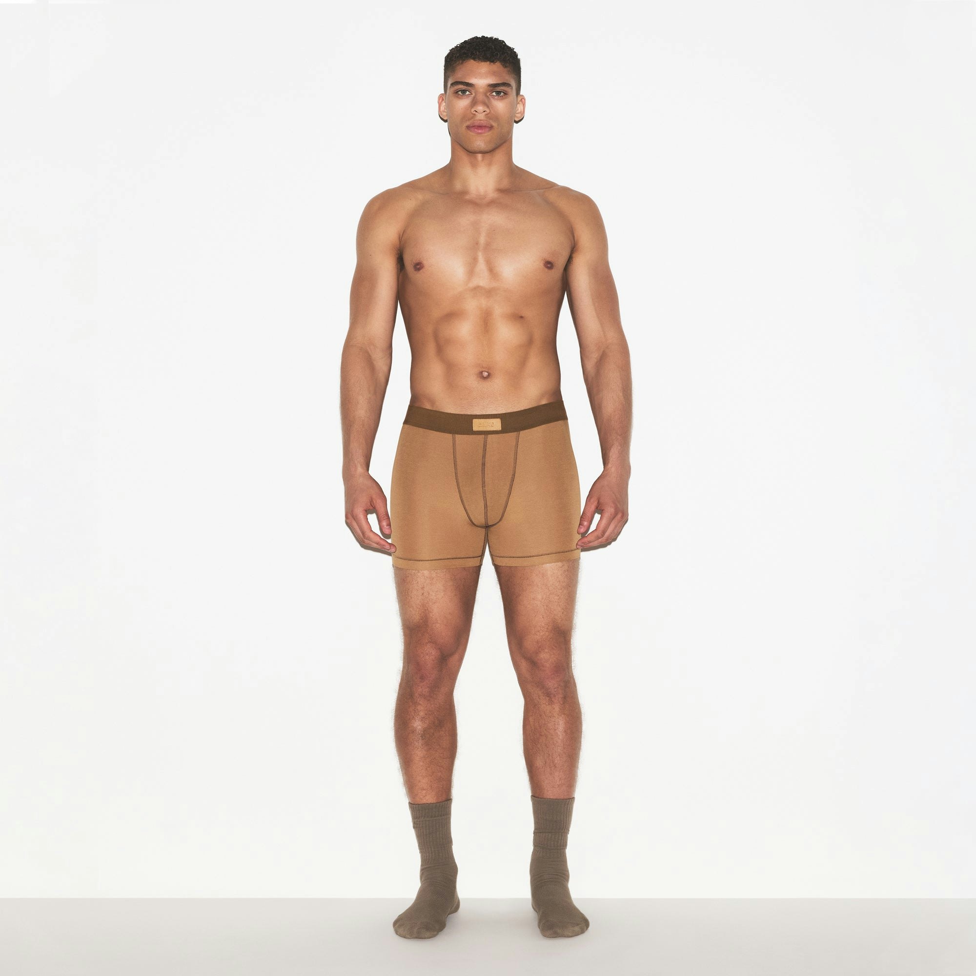 SKIMS COTTON MENS 3 INCH BOXER BRIEF | RUSSET ON A MODEL FRONT VIEW | FOCUS: 0.0, 1.0, 0.9