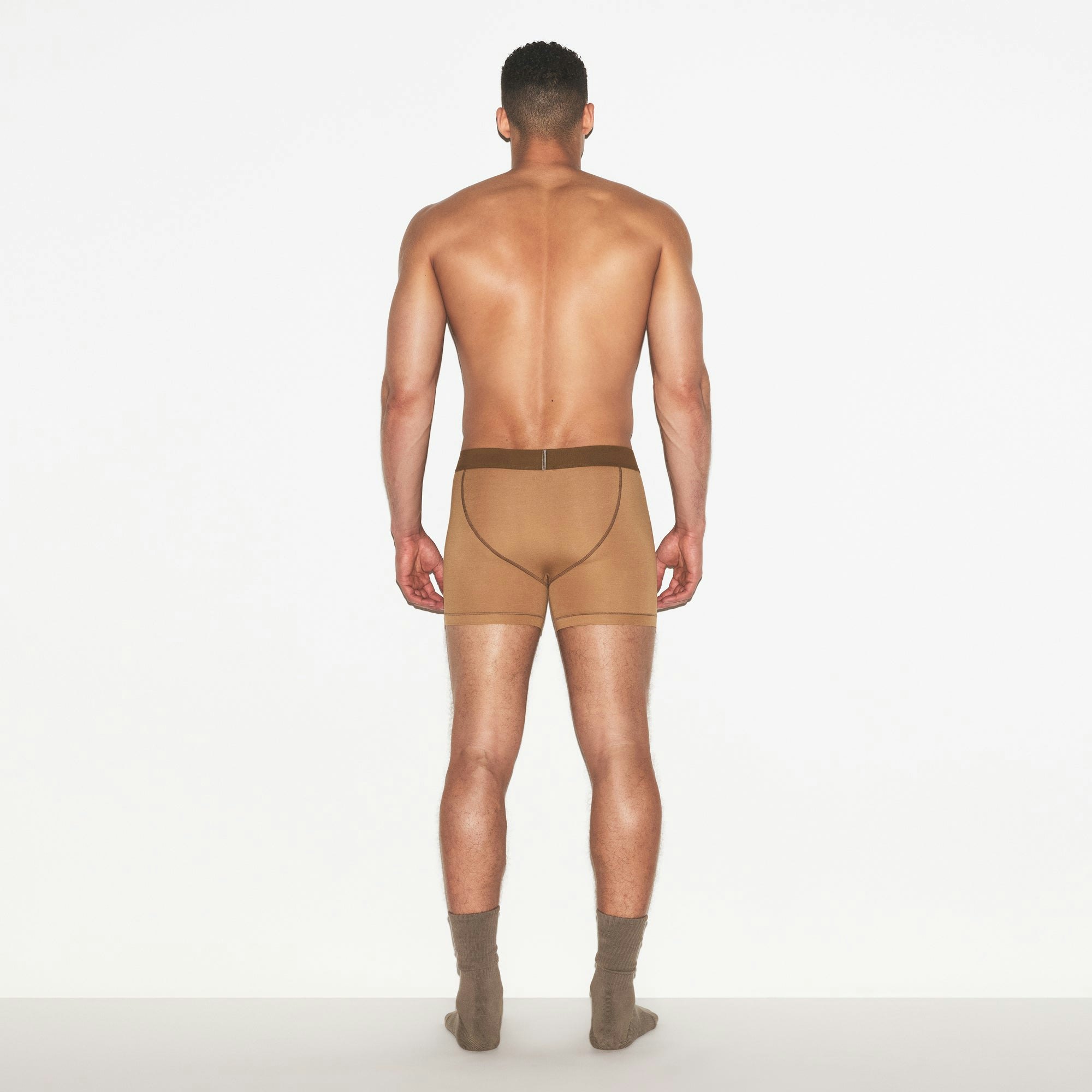 SKIMS COTTON MENS 3 INCH BOXER BRIEF | RUSSET ON A MODEL FRONT VIEW | FOCUS: 0.0, 1.0, 0.9