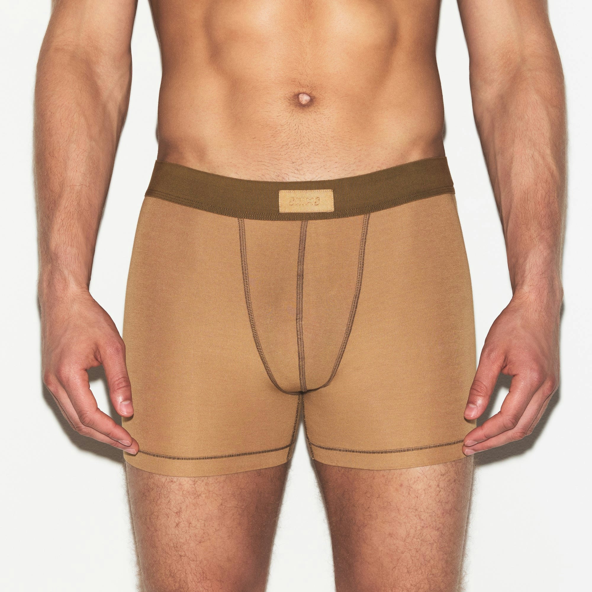 SKIMS COTTON MENS 3 INCH BOXER BRIEF | RUSSET ON A MODEL SIDE VIEW | FOCUS: 0.0, 1.0, 0.9