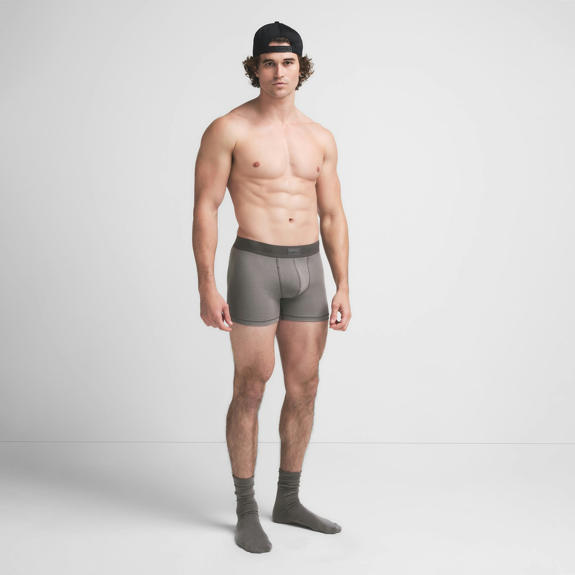 SKIMS COTTON MENS 3" BOXER BRIEF | WASHED GUNMETAL ON A MODEL SIDE VIEW @ | FOCUS: 0.9, 0.1, 0.7