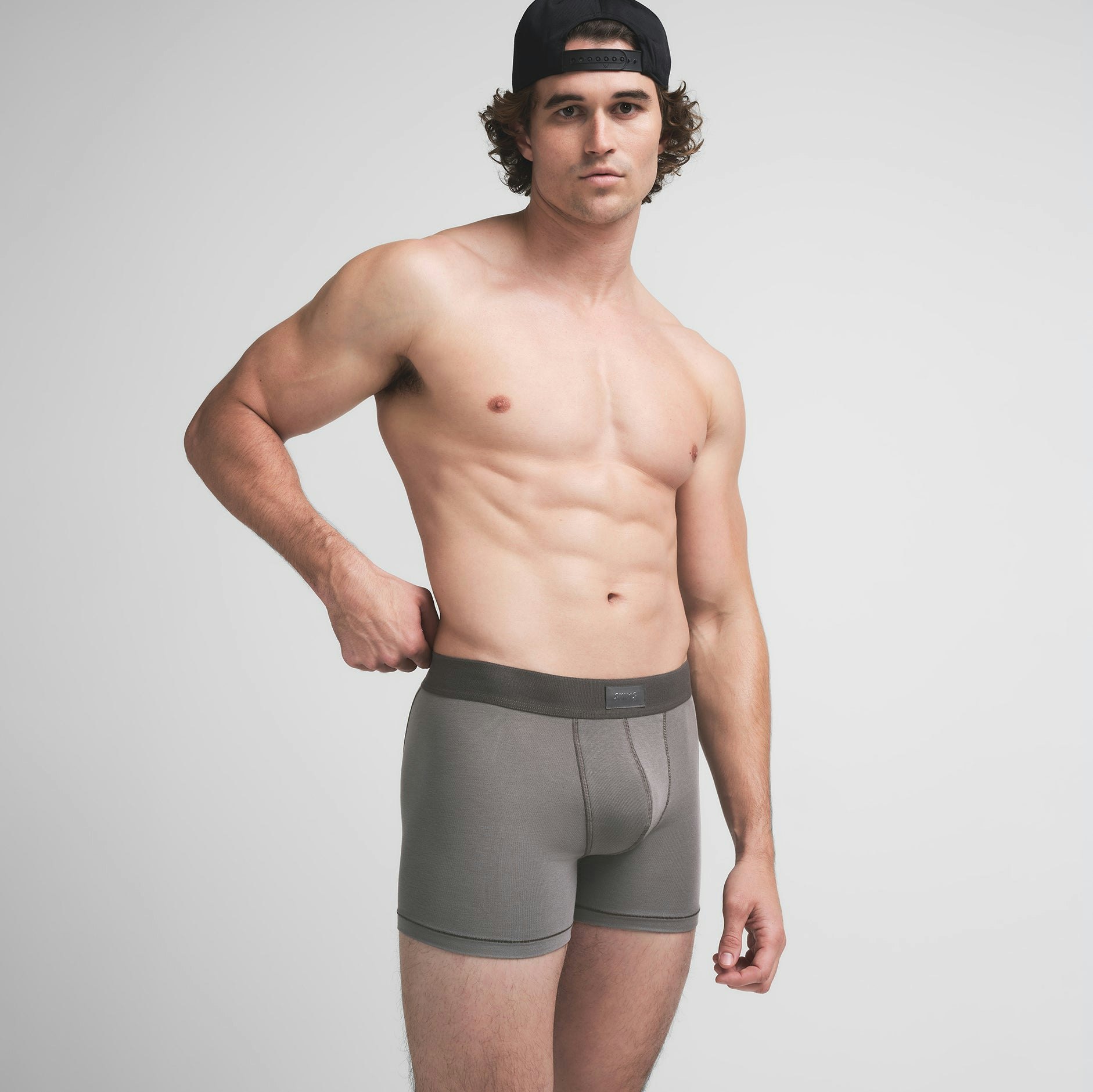 SKIMS COTTON MENS 3" BOXER BRIEF | WASHED GUNMETAL ON A MODEL SIDE VIEW @ | FOCUS: 0.9, 0.1, 0.7