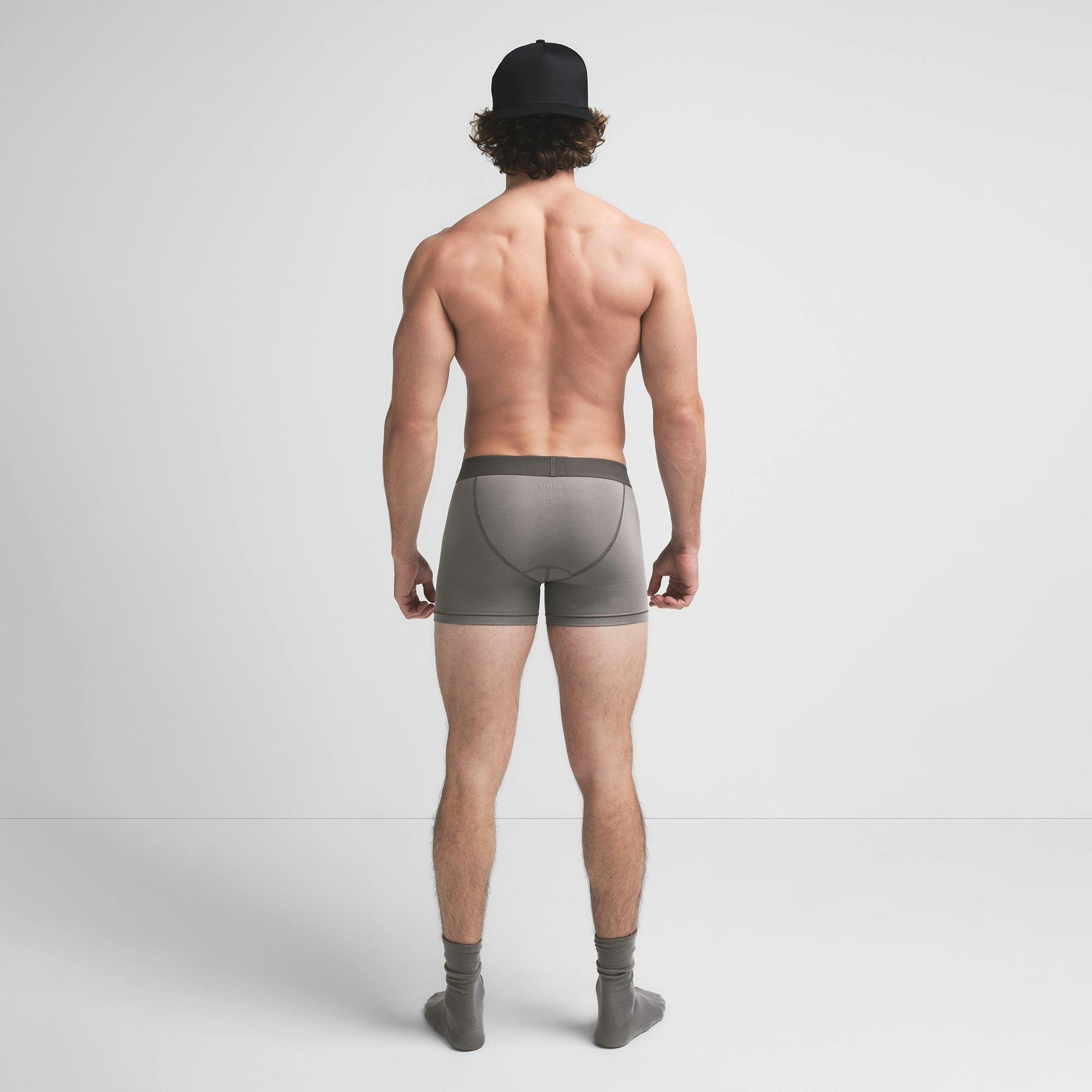SKIMS COTTON MENS 3" BOXER BRIEF | WASHED GUNMETAL ON A MODEL BACK VIEW @ | FOCUS: 0.9, 0.1, 0.7