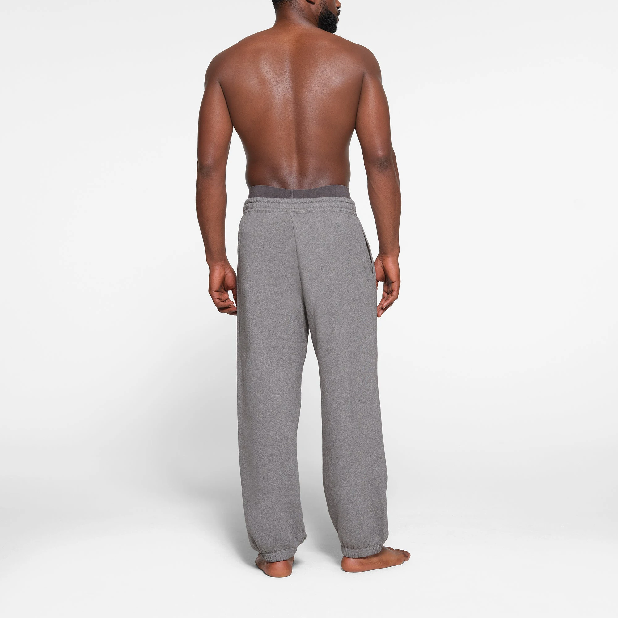 LOUNGE FLEECE MENS RELAXED JOGGER | DARK HEATHER GREY ON A MODEL BACK VIEW