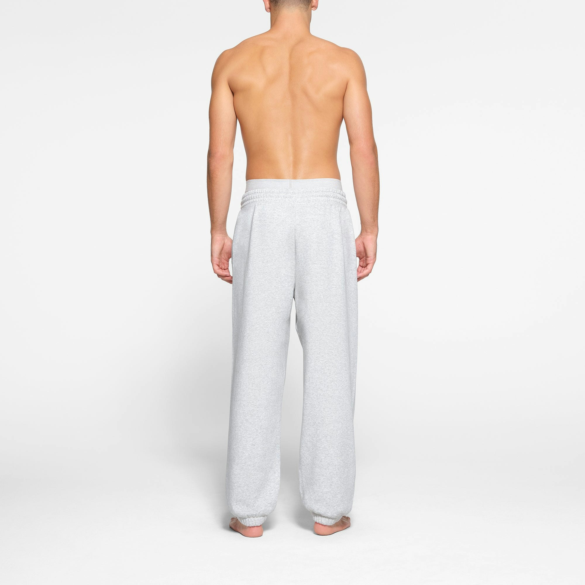 LOUNGE FLEECE MENS RELAXED JOGGER | LIGHT HEATHER GREY ON A MODEL BACK VIEW