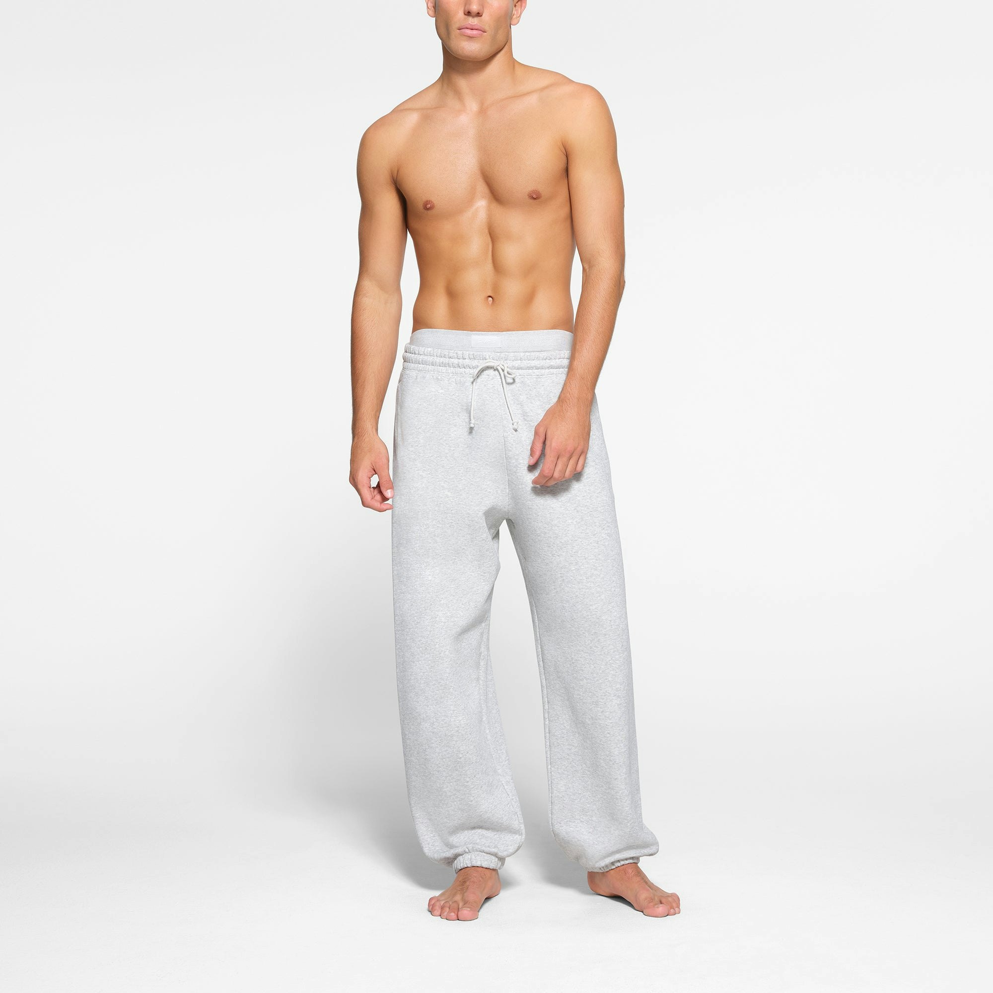 LOUNGE FLEECE MENS RELAXED JOGGER | LIGHT HEATHER GREY ON A MODEL FRONT VIEW