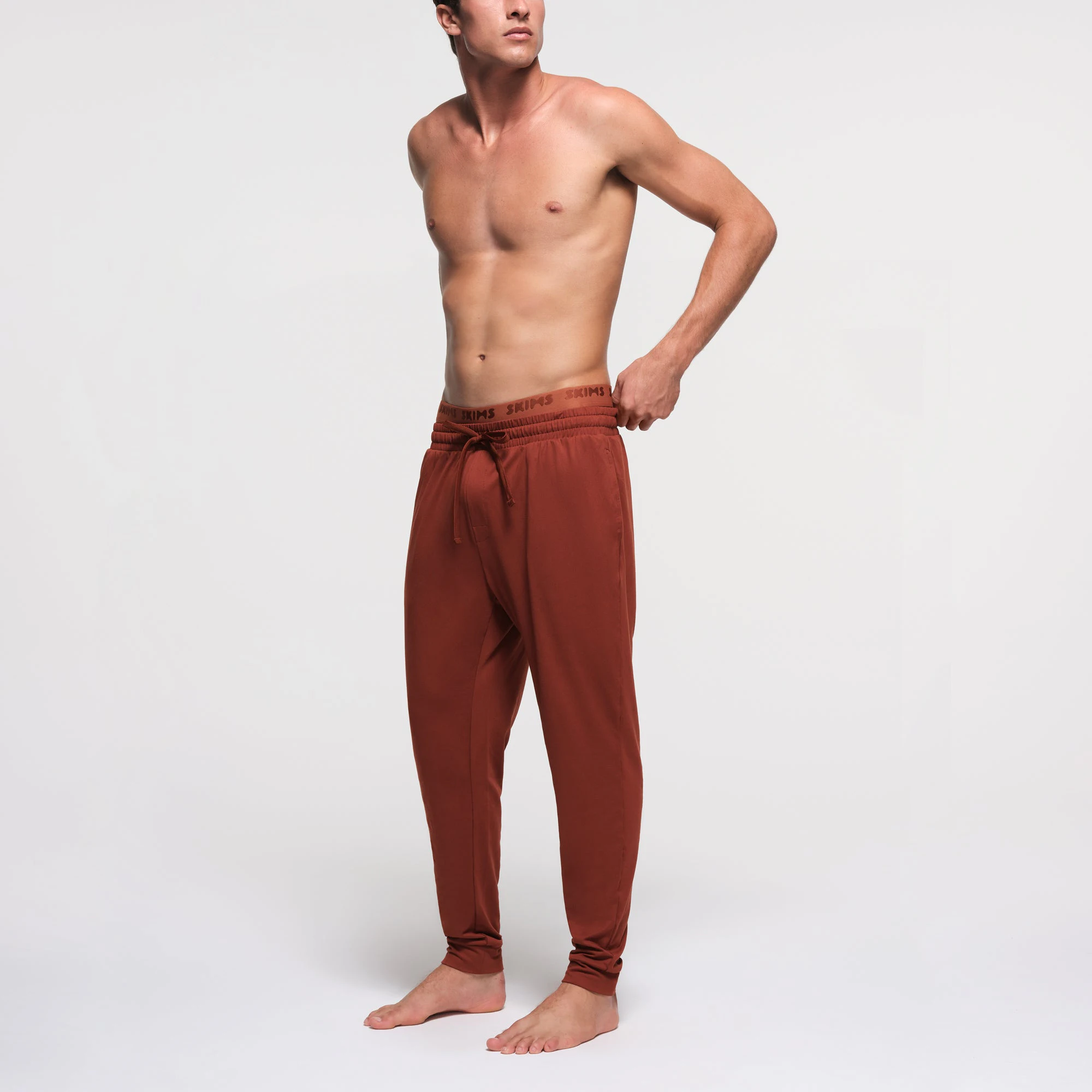 OUTDOOR JERSEY MENS TAPERED JOGGER | RUST ON A MODEL SIDE VIEW