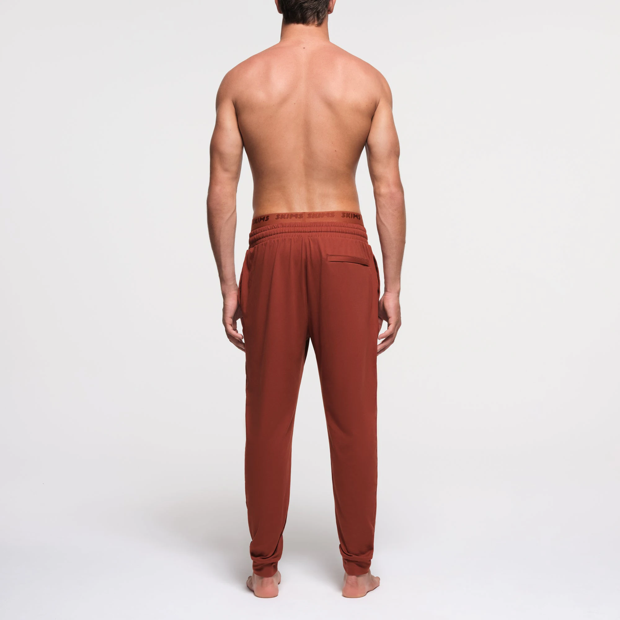 OUTDOOR JERSEY MENS TAPERED JOGGER | RUST ON A MODEL BACK VIEW