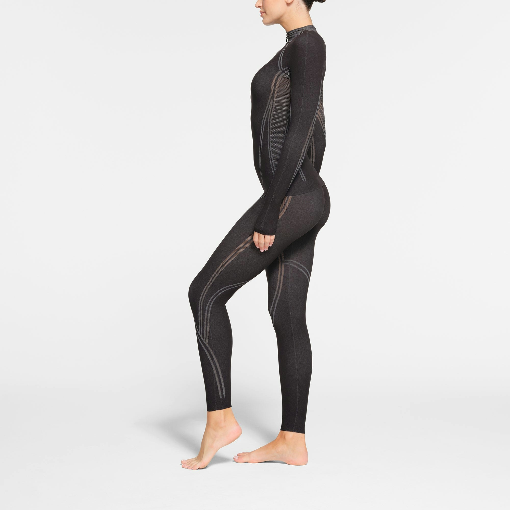 SKIMS FIRST LAYERS LEGGING | ONYX ON A MODEL SIDE VIEW