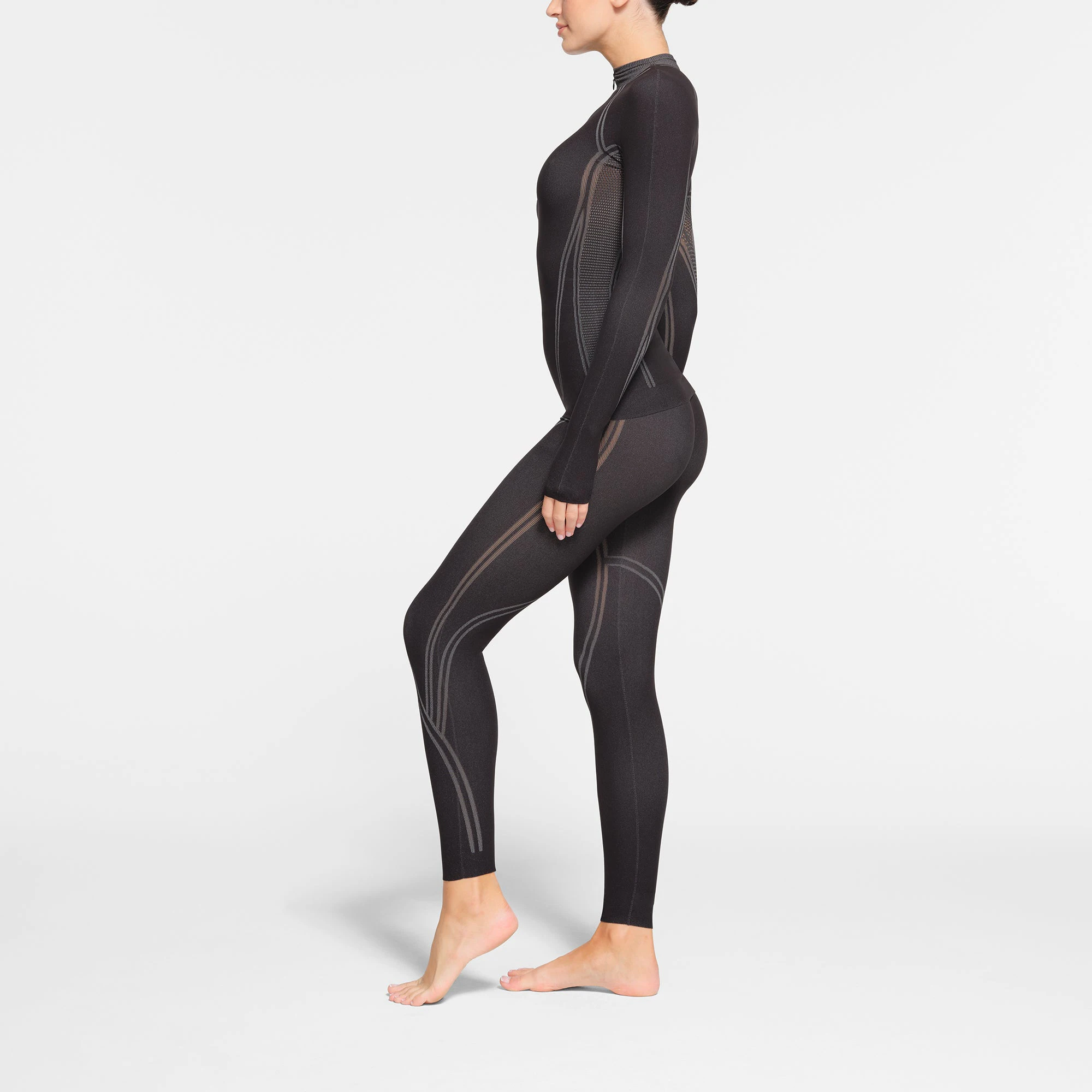 SKIMS FIRST LAYERS LEGGING | ONYX ON A MODEL SIDE VIEW