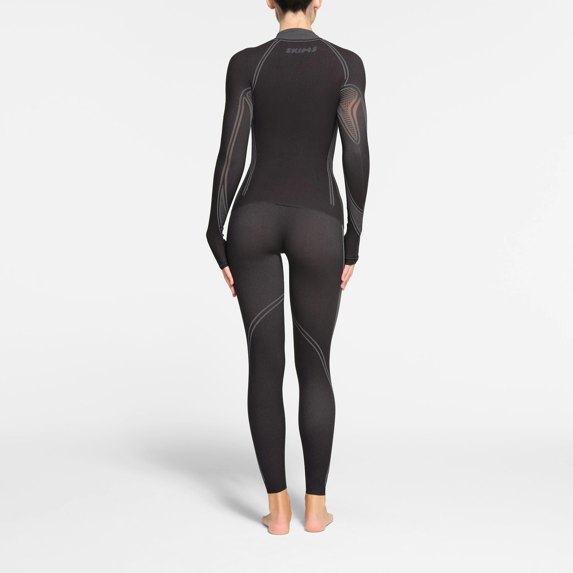 SKIMS FIRST LAYERS LEGGING | ONYX ON A MODEL BACK VIEW