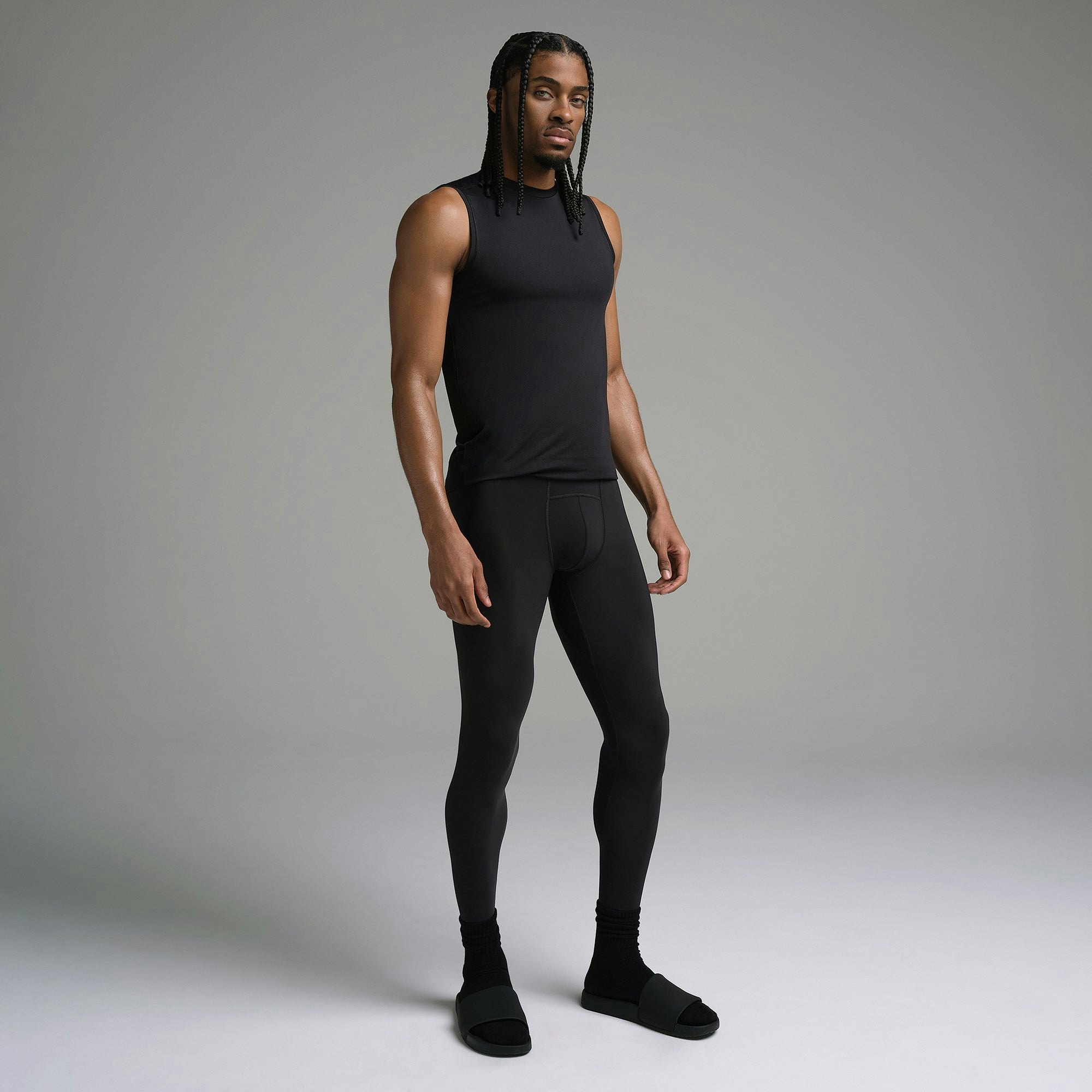 SKIMS SPORT MENS LEGGING | OBSIDIAN ON A MODEL SIDE VIEW | FOCUS: 0.0, 1.0, 0.9