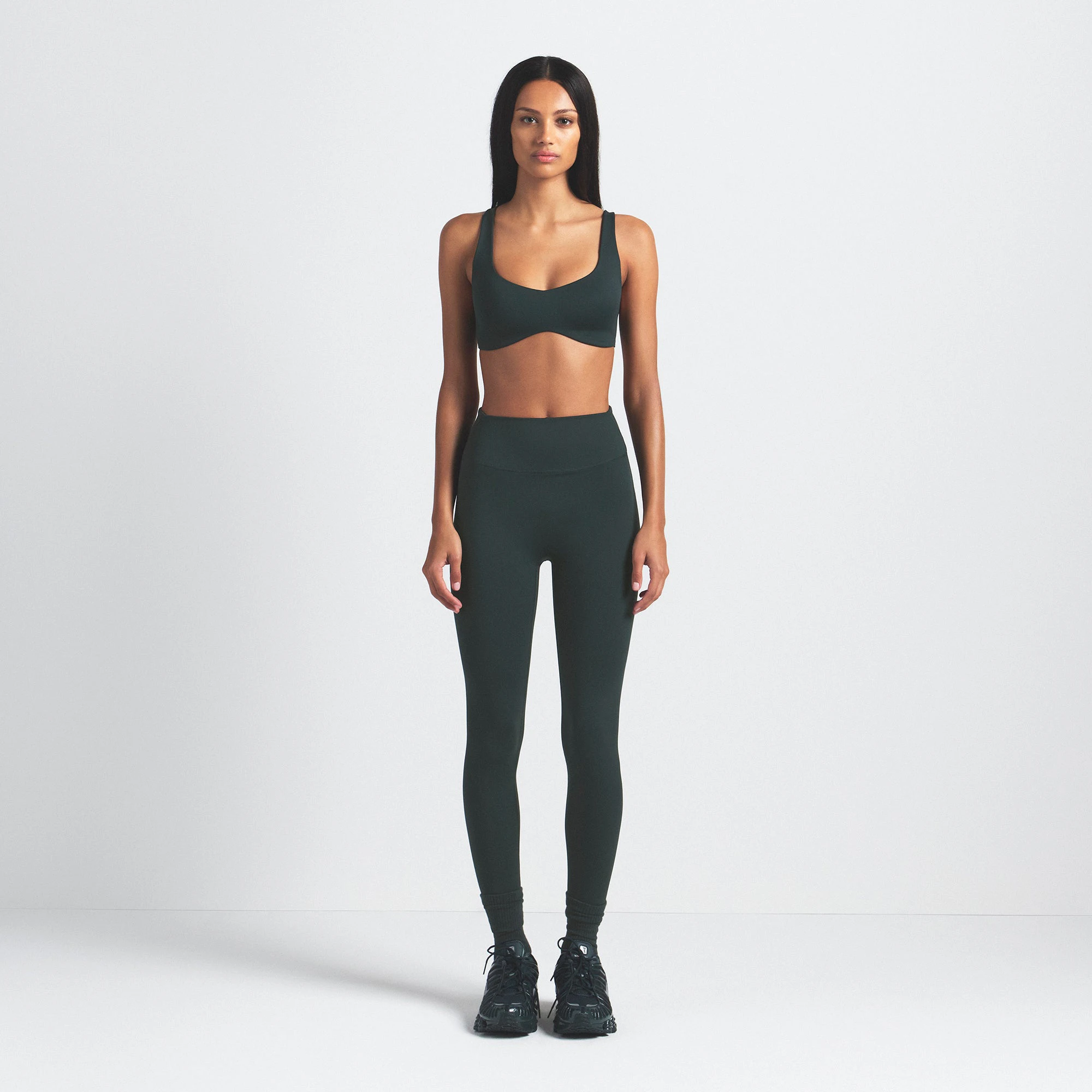 NikeSKIMS MATTE 26" LEGGING | DARK TEAL ON A MODEL FRONT VIEW @ | FOCUS: 0.0, 1.0, 0.9