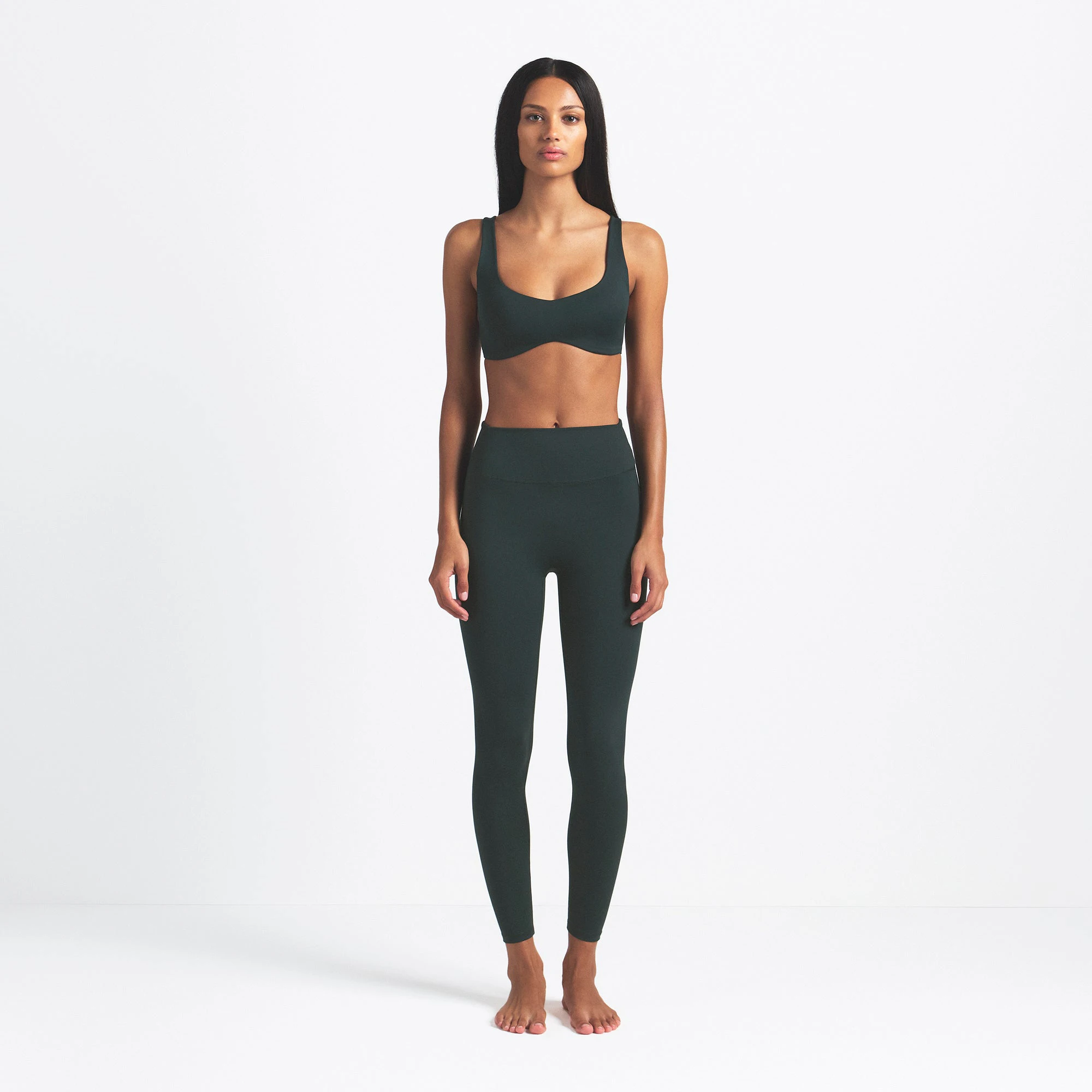 NikeSKIMS MATTE 26" LEGGING | DARK TEAL ON A MODEL FRONT VIEW @ | FOCUS: 0.0, 1.0, 0.9