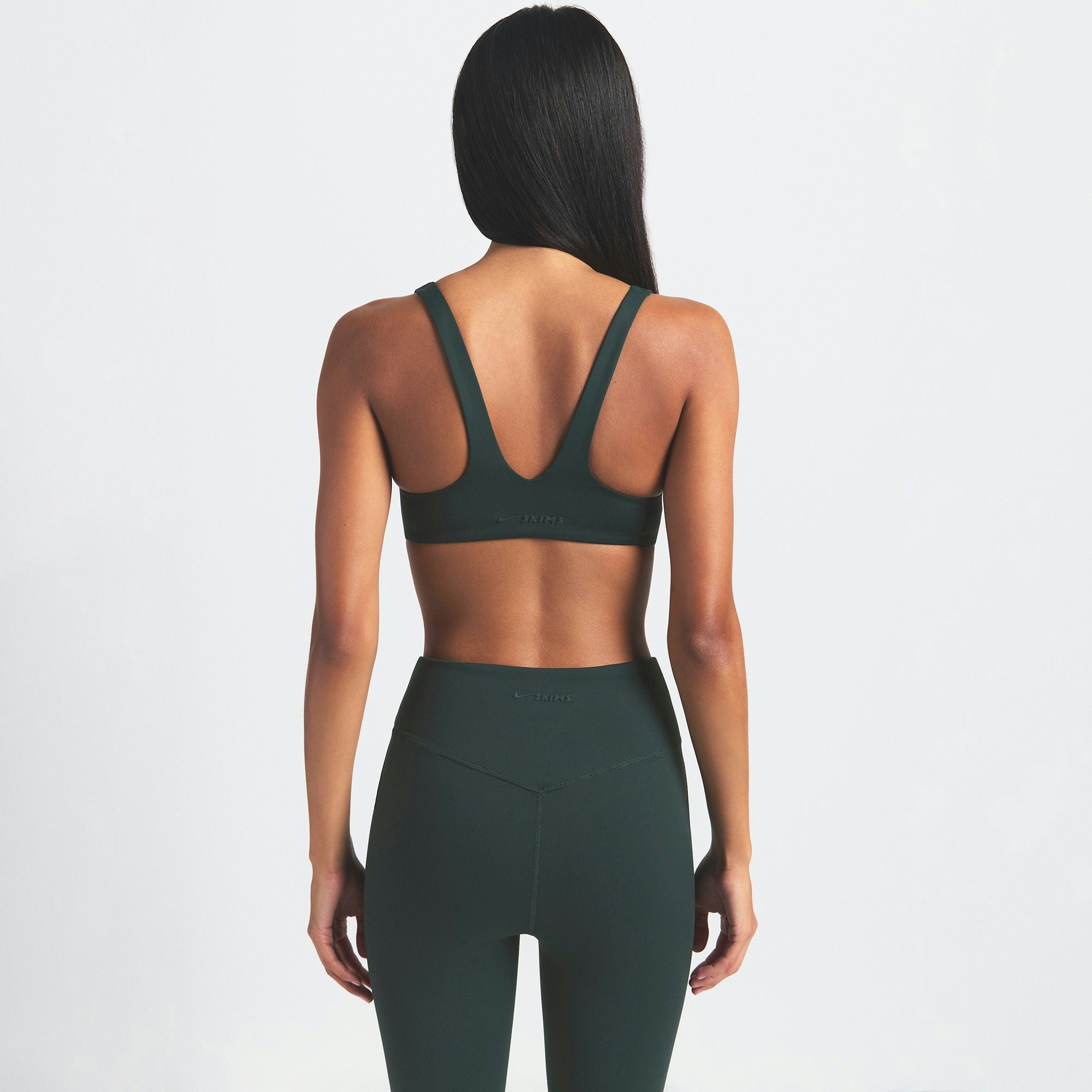 NikeSKIMS MATTE 26" LEGGING | DARK TEAL ON A MODEL SIDE VIEW @ | FOCUS: 0.0, 1.0, 0.9