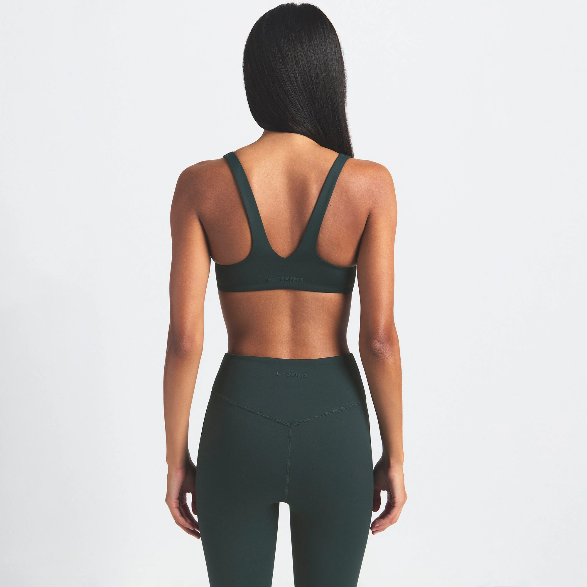 NikeSKIMS MATTE 26" LEGGING | DARK TEAL ON A MODEL SIDE VIEW @ | FOCUS: 0.0, 1.0, 0.9