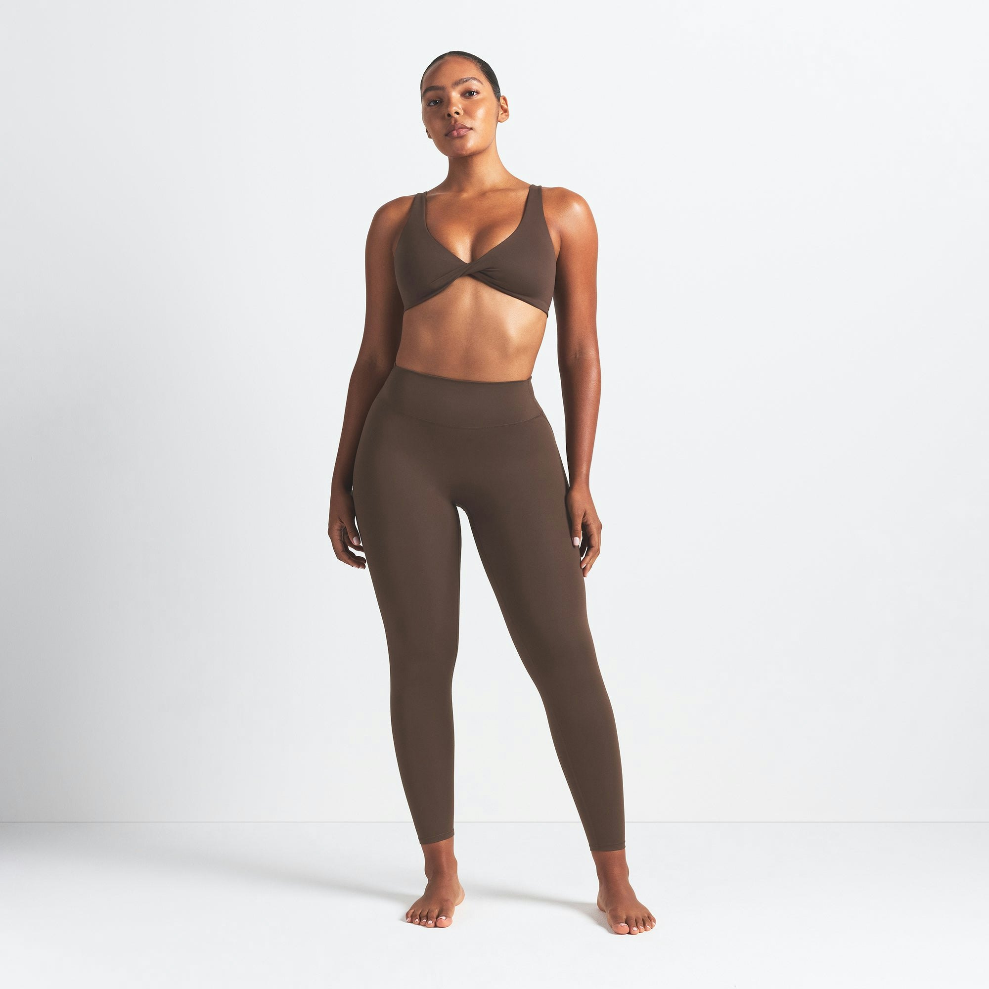 NikeSKIMS MATTE 26" LEGGING | DARK SEPIA ON A MODEL FRONT VIEW
