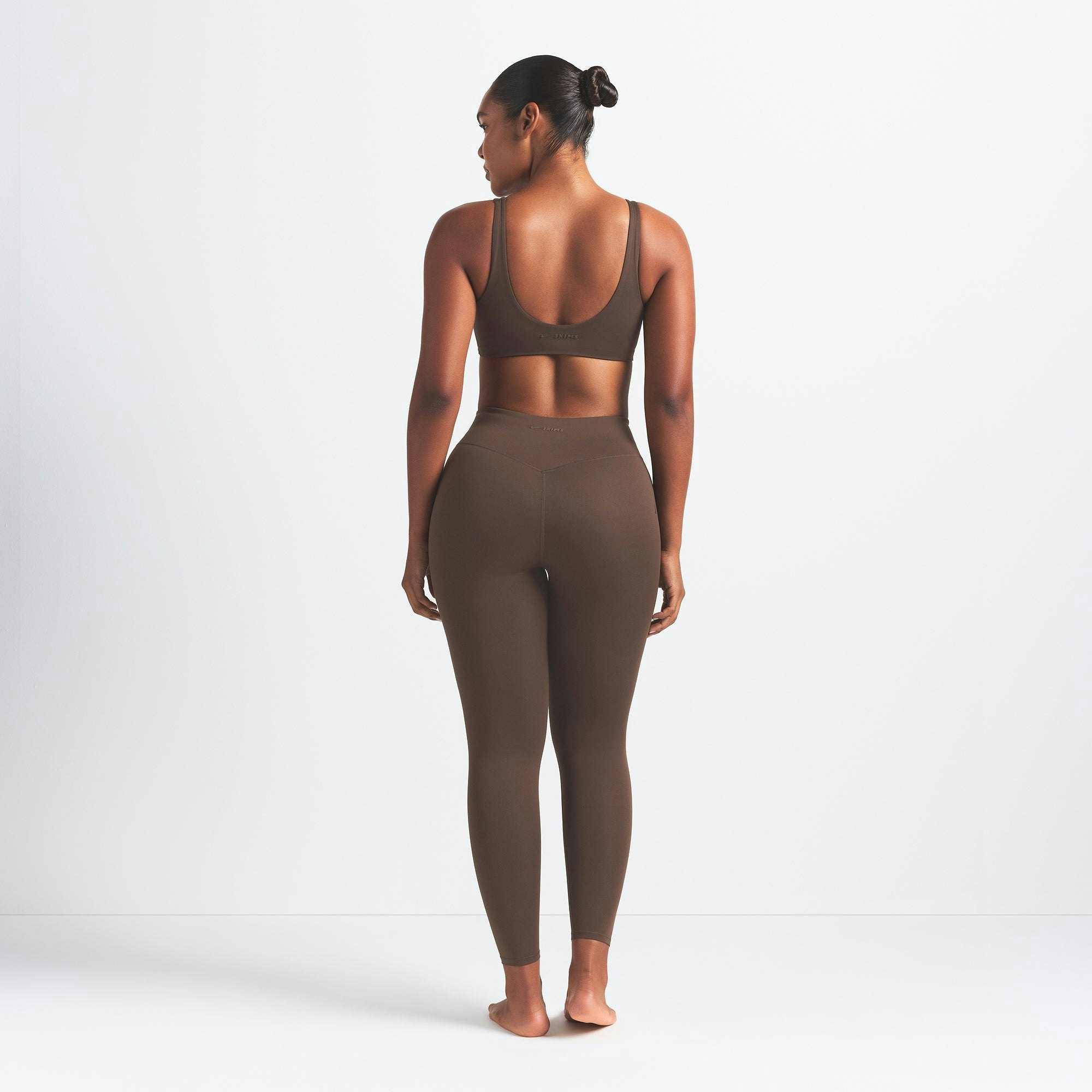 NikeSKIMS MATTE 26" LEGGING | DARK SEPIA ON A MODEL BACK VIEW