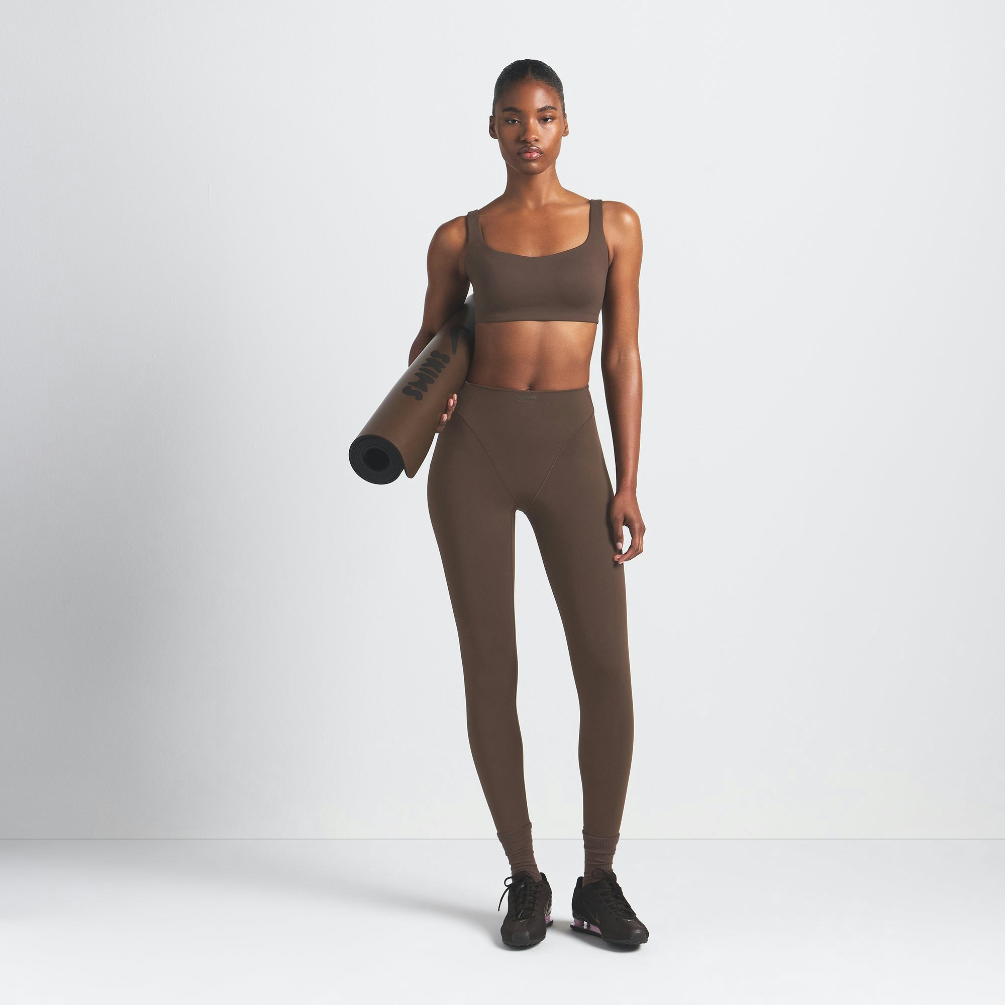 NikeSKIMS MATTE V-LINE 26" LEGGING | DARK SEPIA ON A MODEL FRONT VIEW @ | FOCUS: 0.9, 0.1, 0.7