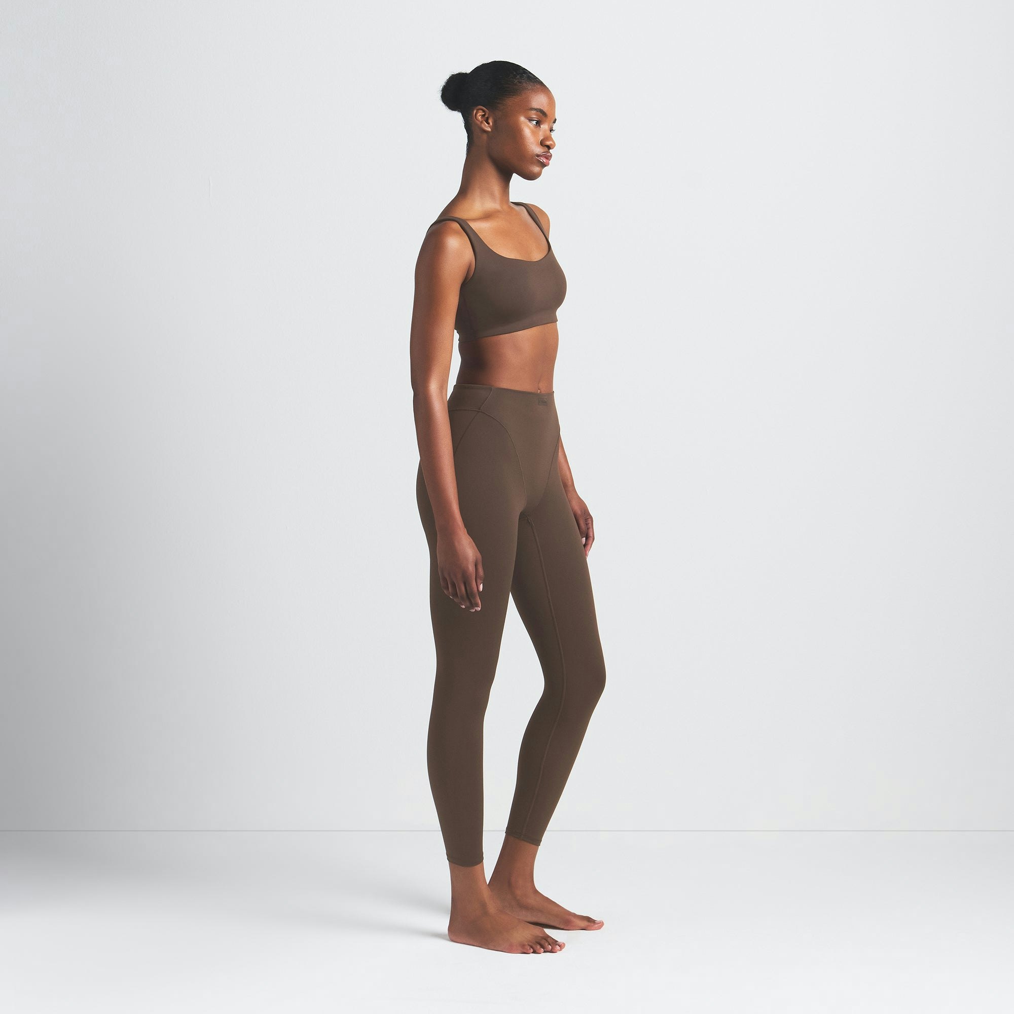 NikeSKIMS MATTE V-LINE 26" LEGGING | DARK SEPIA ON A MODEL SIDE VIEW