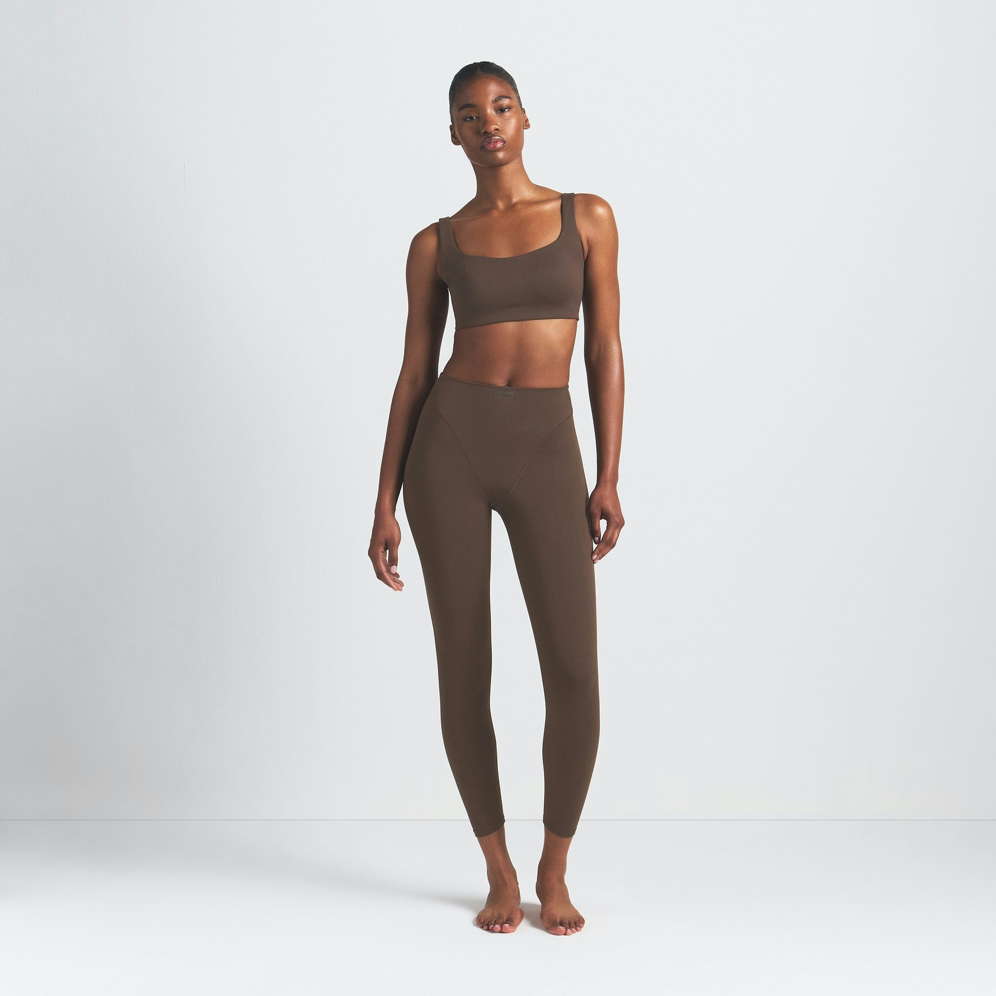 NikeSKIMS MATTE V-LINE 26" LEGGING | DARK SEPIA ON A MODEL FRONT VIEW