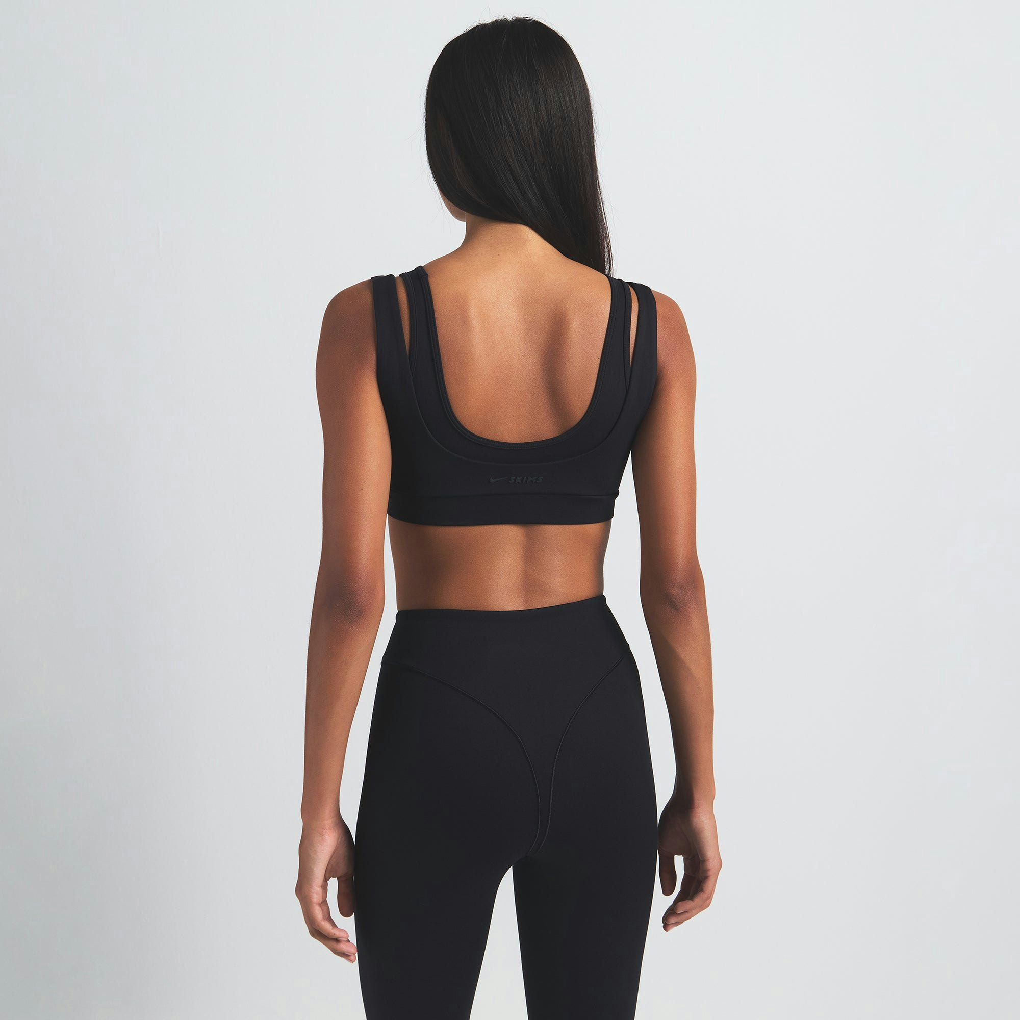 NikeSKIMS MATTE V-LINE 26" LEGGING | OBSIDIAN ON A MODEL BACK VIEW