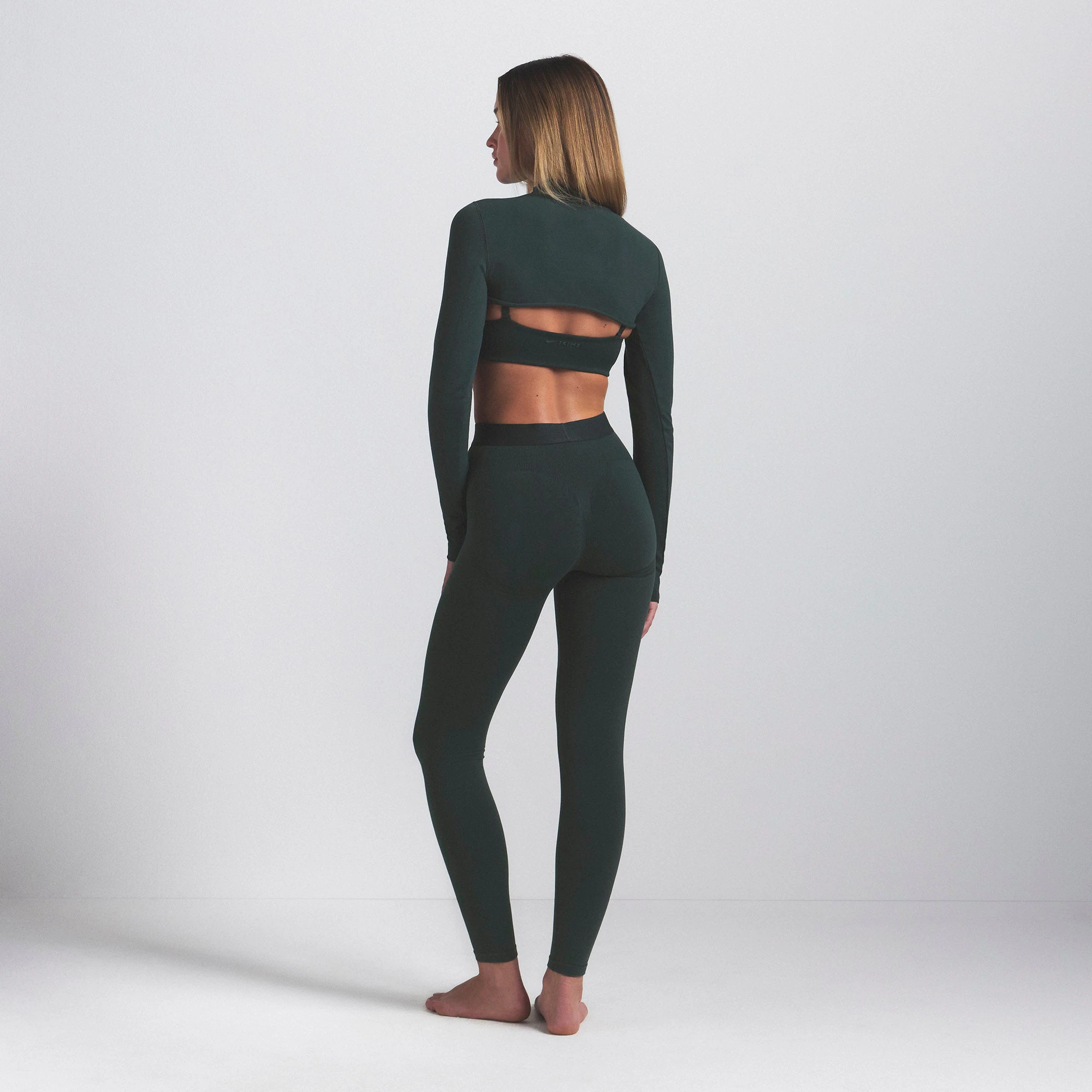 NikeSKIMS VINTAGE SEAMLESS 26" LEGGING | DARK TEAL ON A MODEL SIDE VIEW