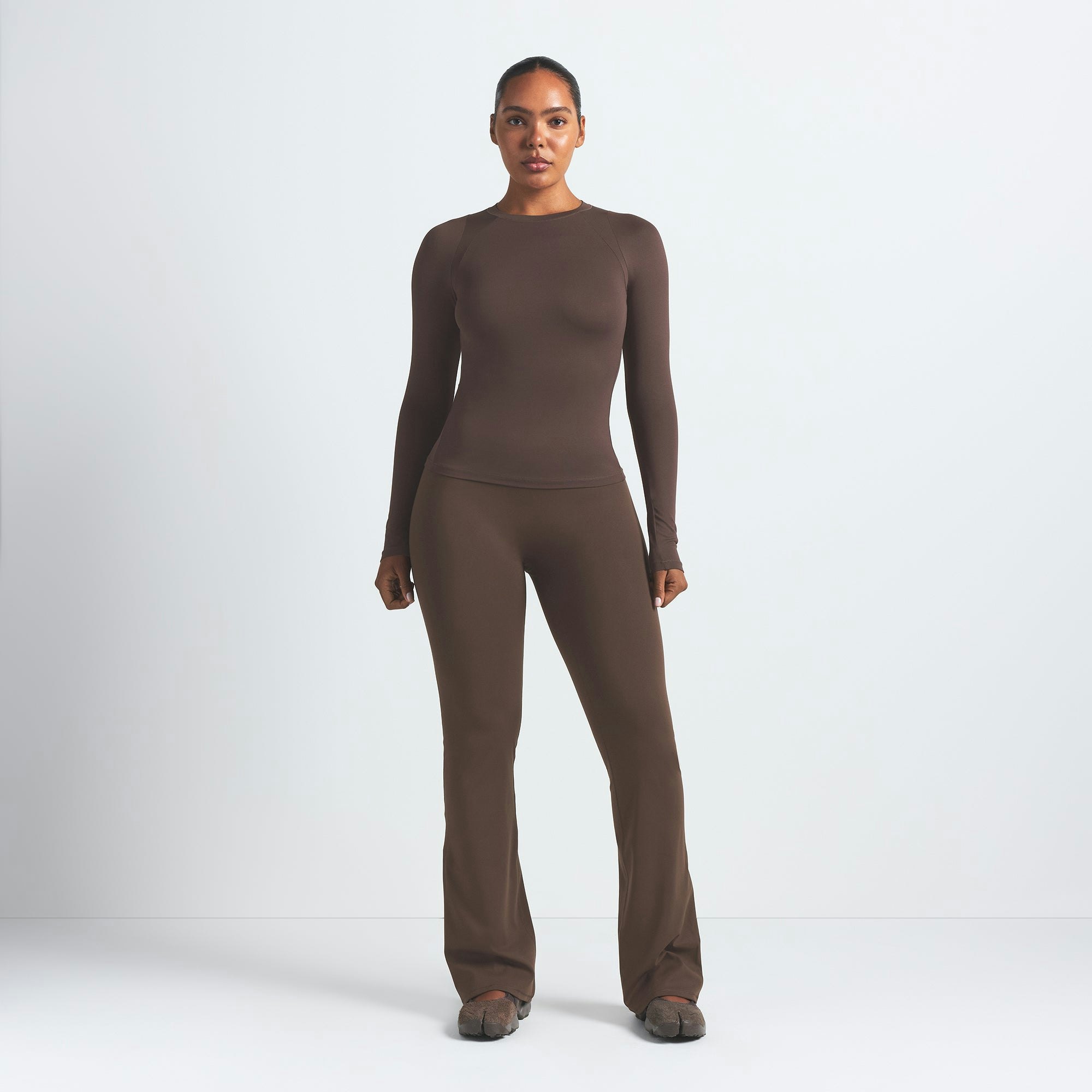 NikeSKIMS MATTE SLIM FLARE LEGGING | DARK SEPIA ON A MODEL FRONT VIEW