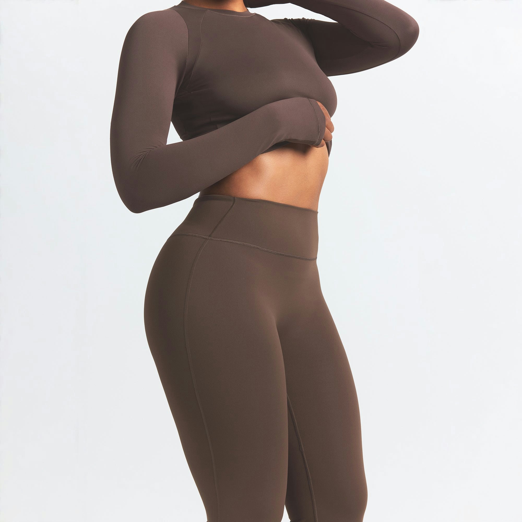 NikeSKIMS MATTE SLIM FLARE LEGGING | DARK SEPIA ON A MODEL SIDE VIEW