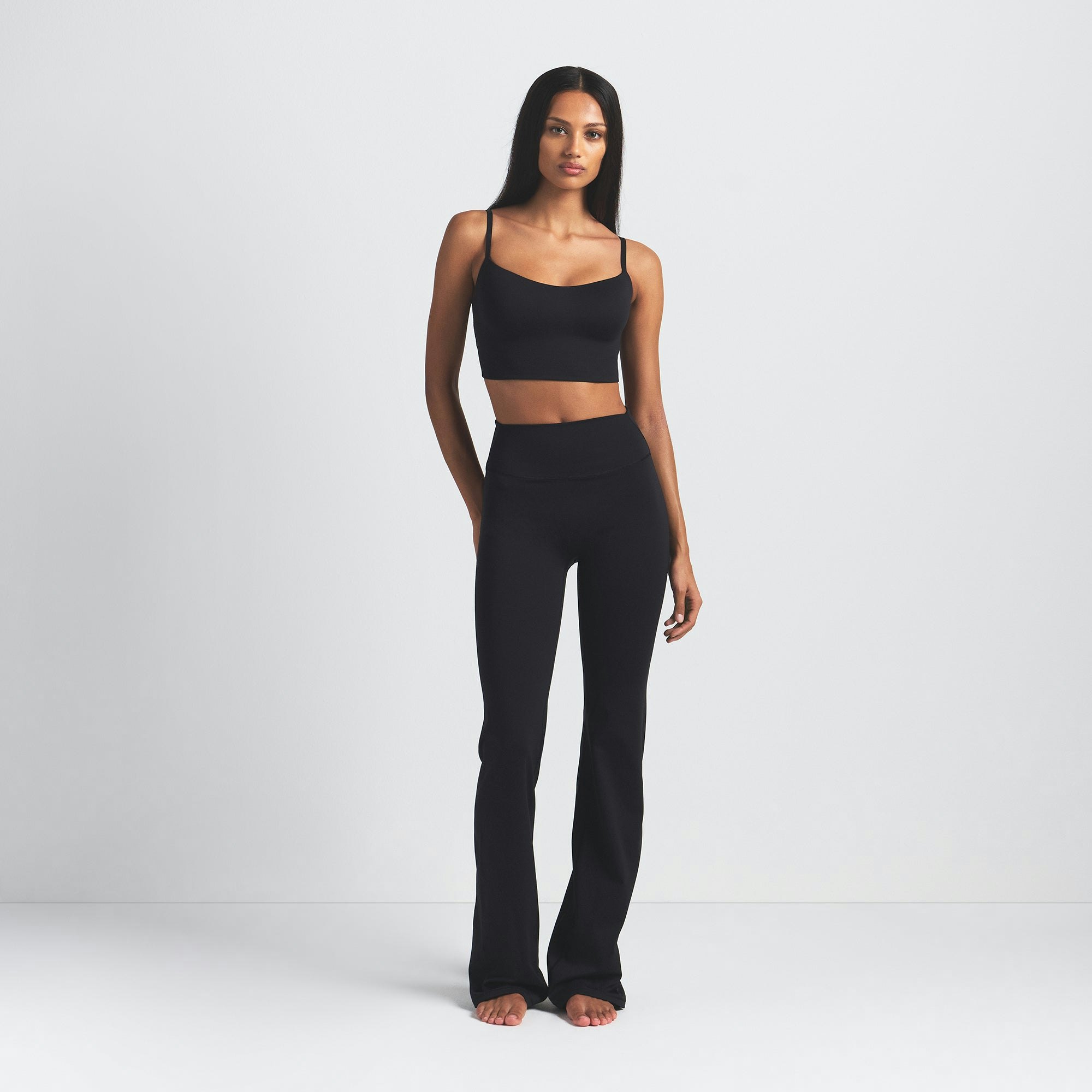 NikeSKIMS MATTE SLIM FLARE LEGGING | OBSIDIAN ON A MODEL FRONT VIEW