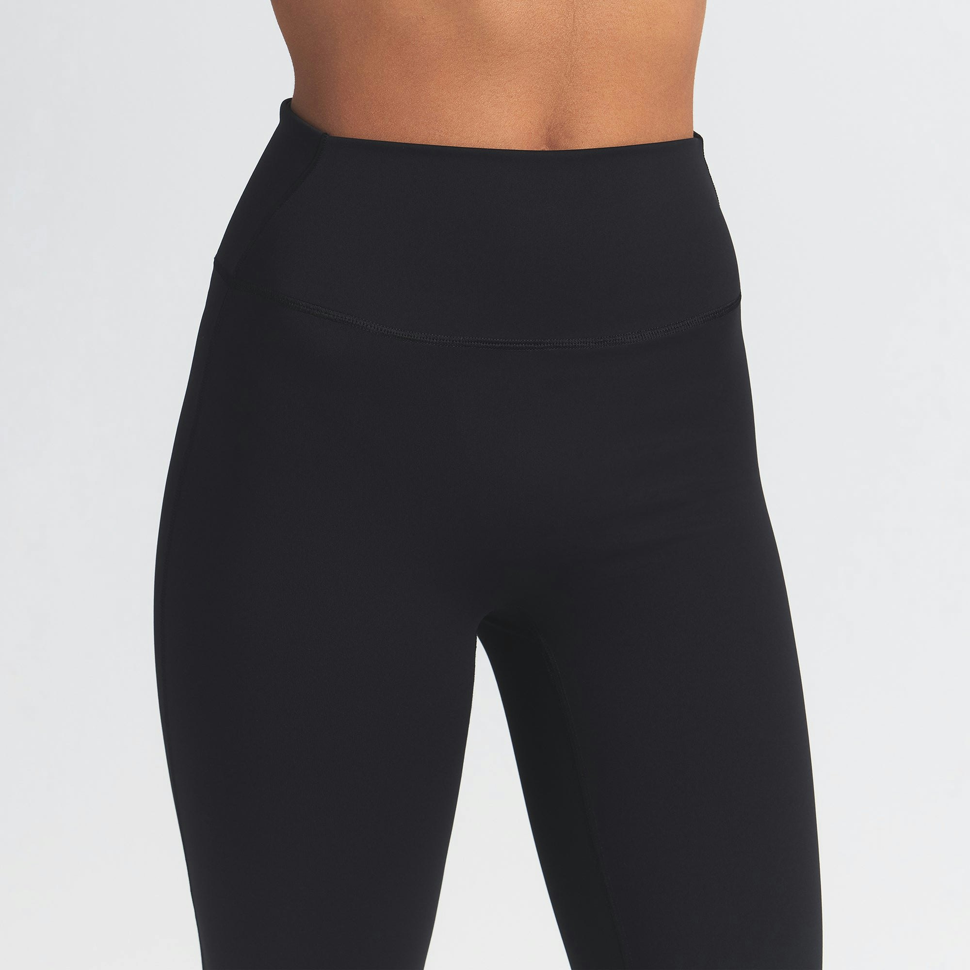NikeSKIMS MATTE SLIM FLARE LEGGING | OBSIDIAN ON A MODEL FRONT VIEW