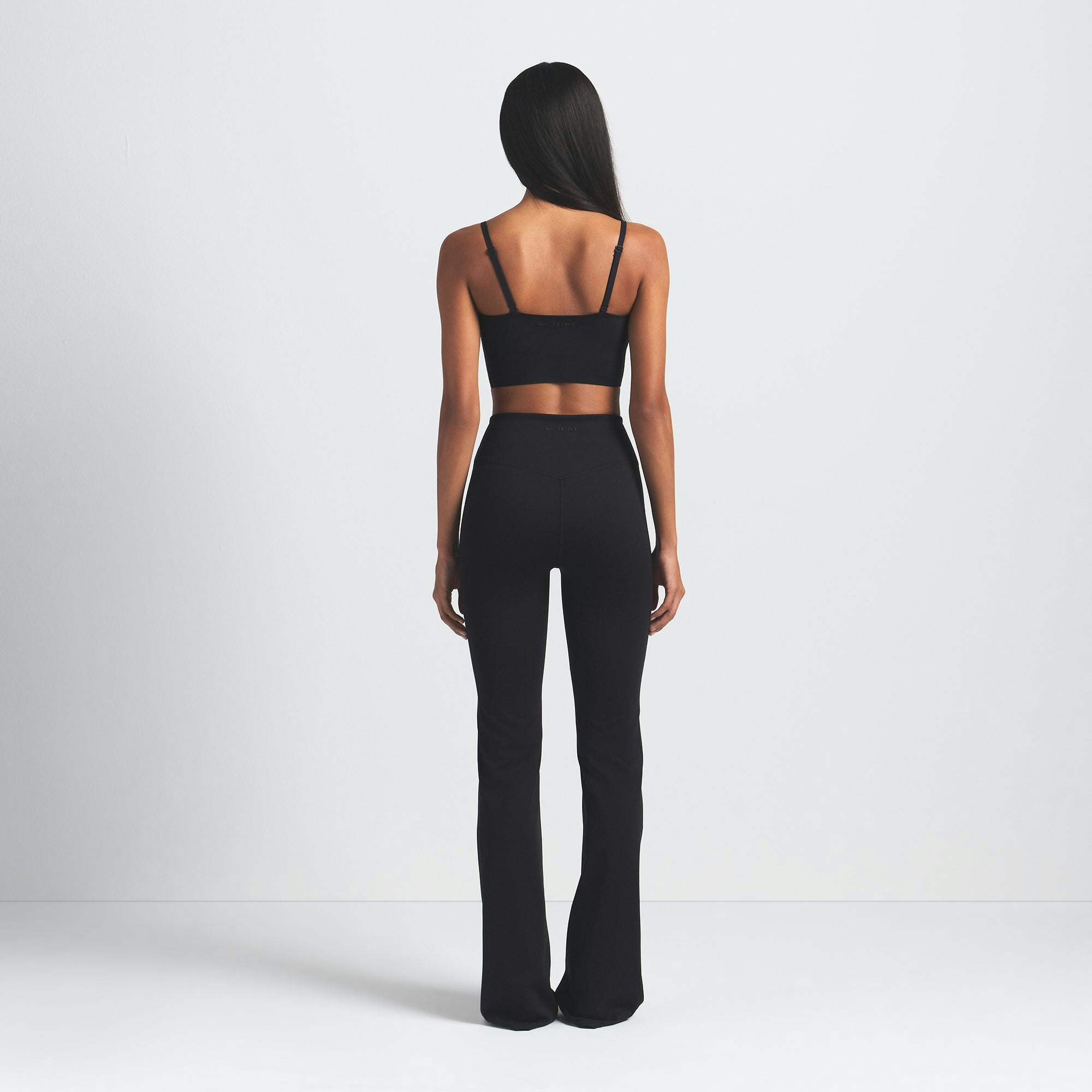 NikeSKIMS MATTE SLIM FLARE LEGGING | OBSIDIAN ON A MODEL BACK VIEW