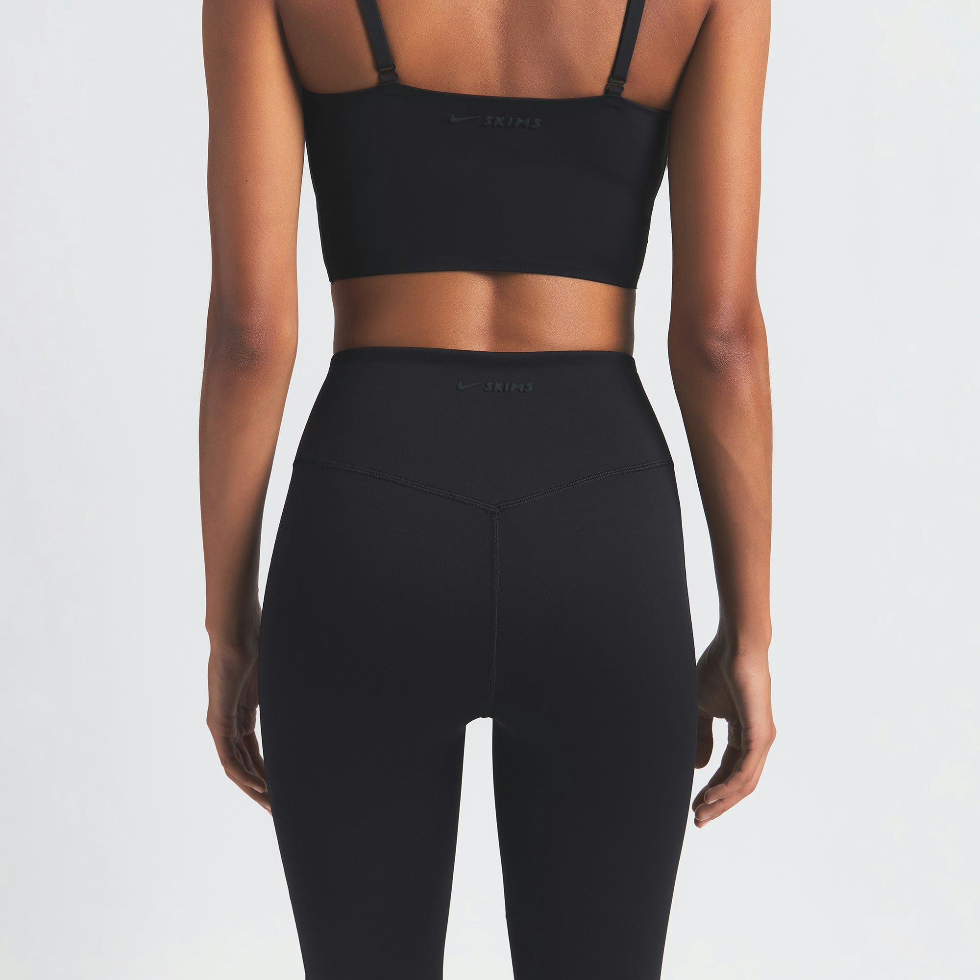 NikeSKIMS MATTE SLIM FLARE LEGGING | OBSIDIAN ON A MODEL BACK VIEW
