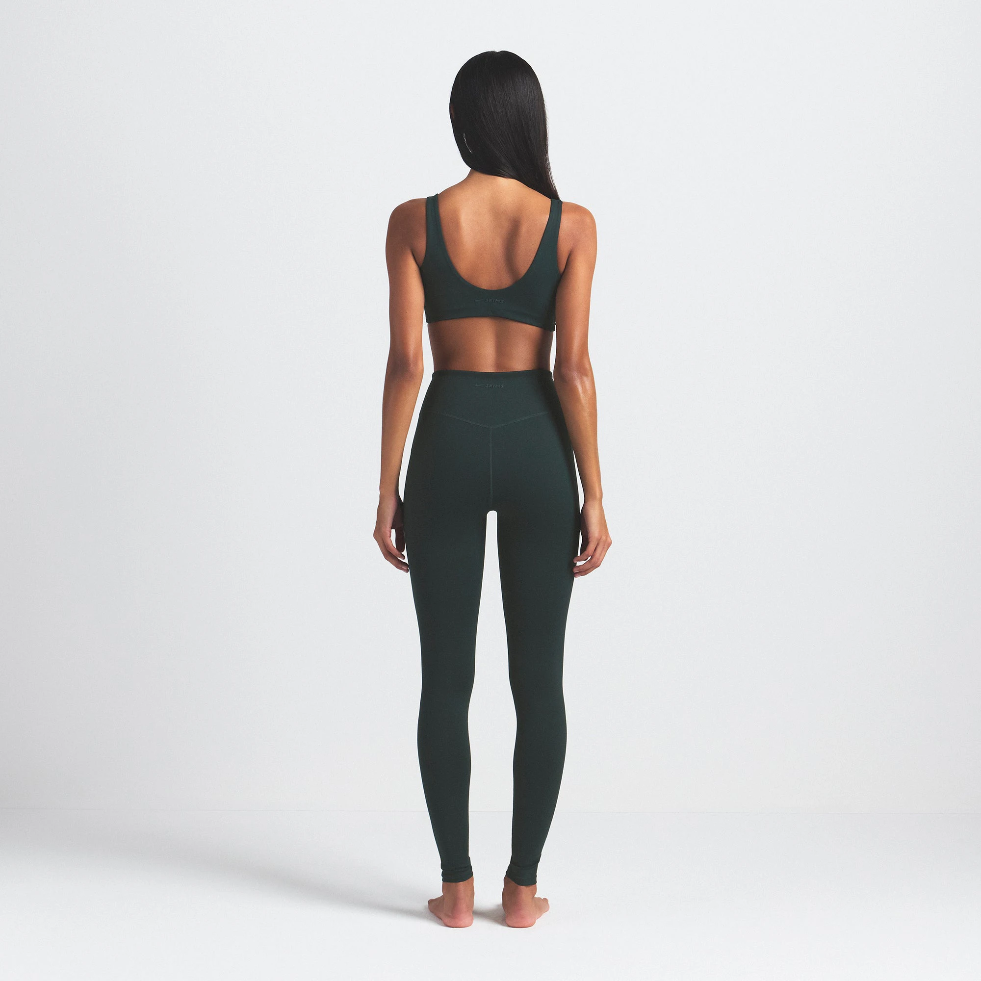 NikeSKIMS MATTE 29" LEGGING | DARK TEAL ON A MODEL SIDE VIEW @ | FOCUS: 0.0, 1.0, 0.9